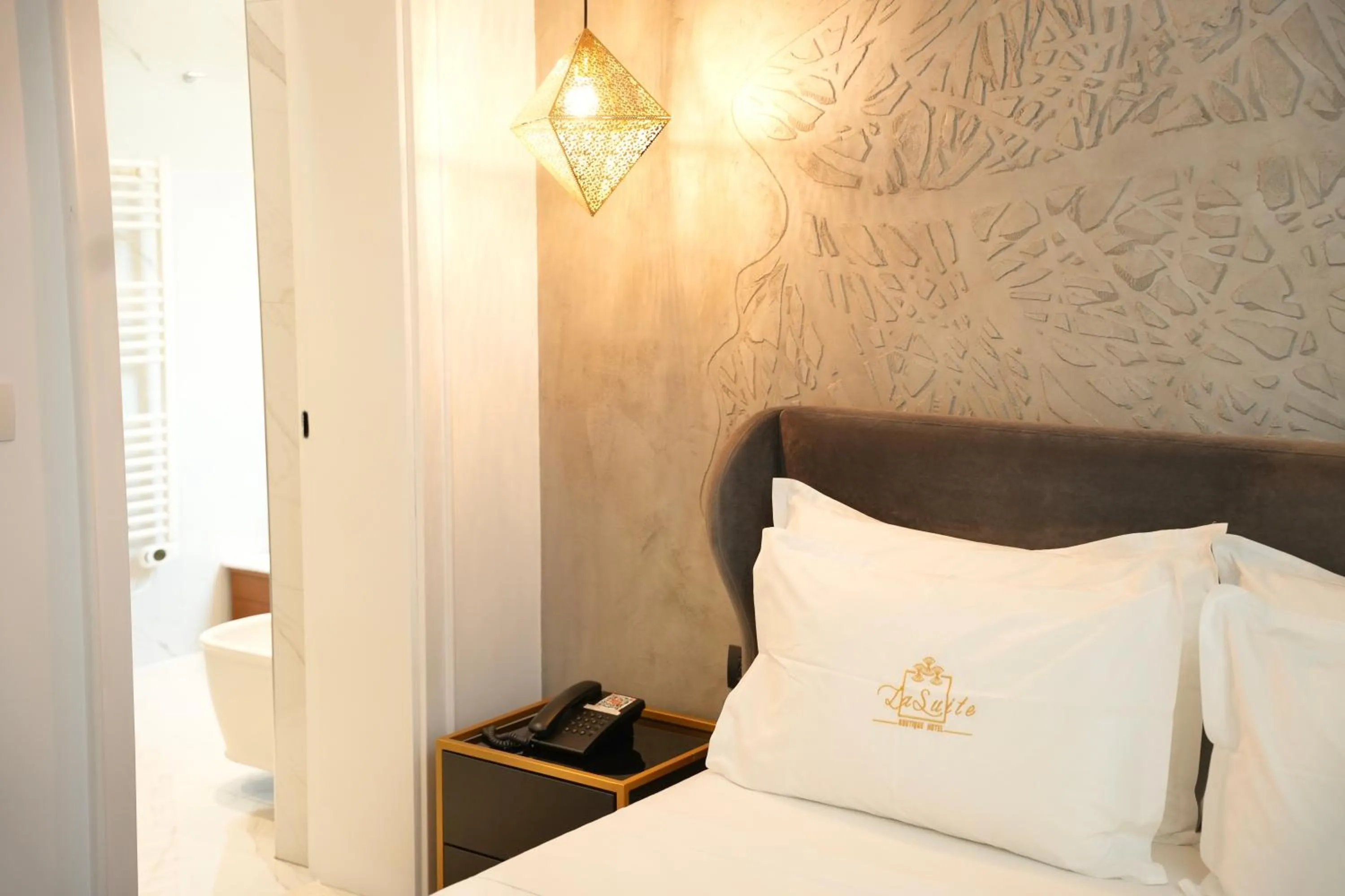 Bed in La Suite Boutique Hotel