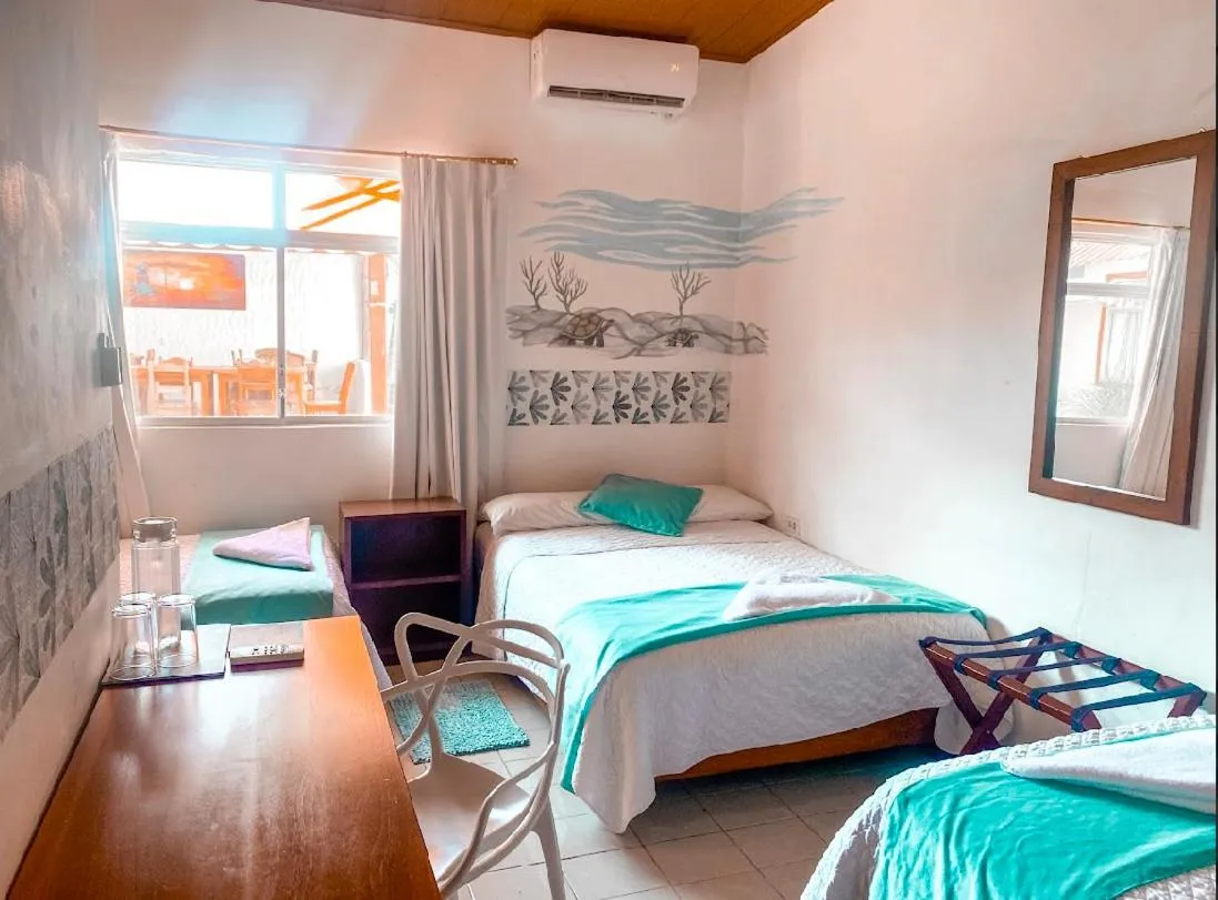 Photo of the whole room, Bed in Hotel Coral Blanco with high speed internet Starlink and Galapagos Tour Operator