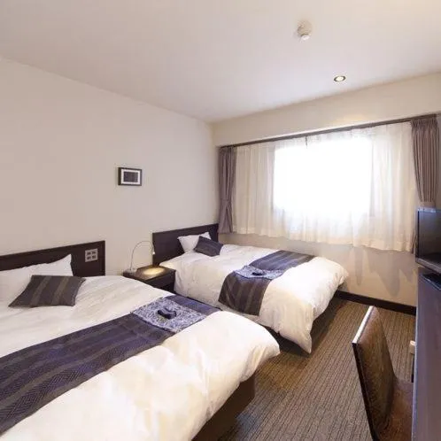 Photo of the whole room, Bed in Silk Inn Kagoshima