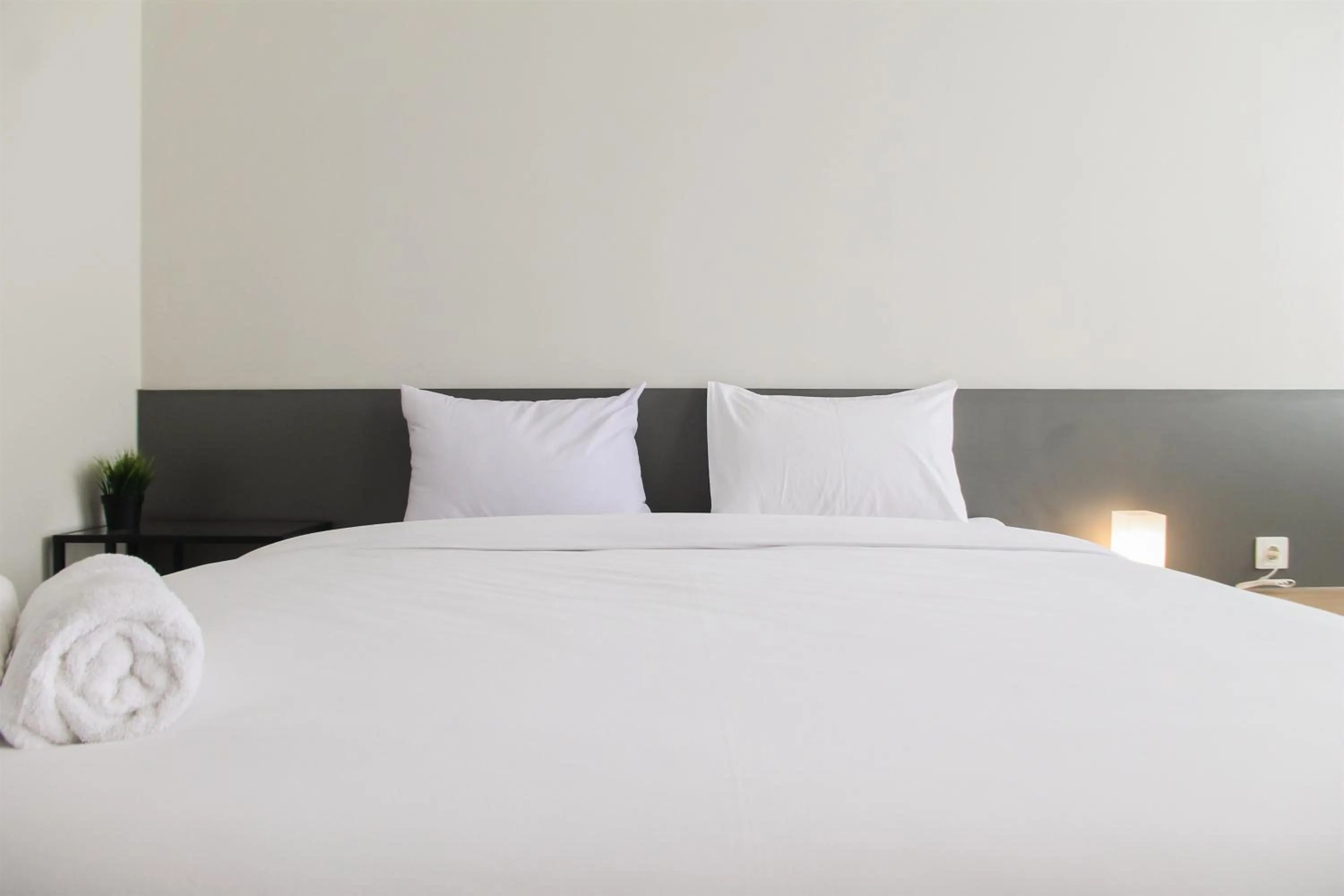 Bed in Comfy Studio Room The Oasis Cikarang Apartment By Travelio