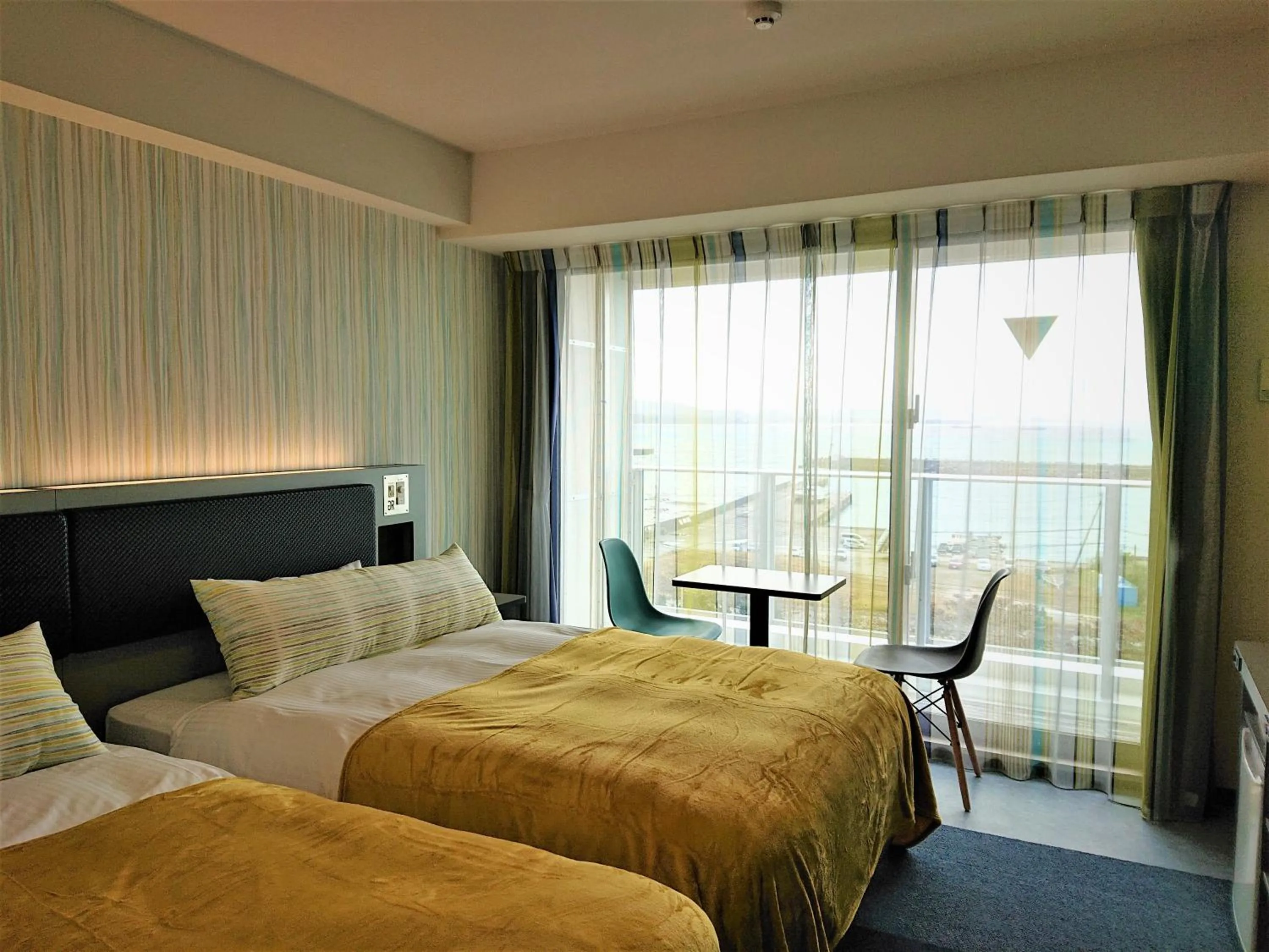 Bed in Green Rich Hotel Okinawa Nago (Artificial hot spring Futamata Yunohana)