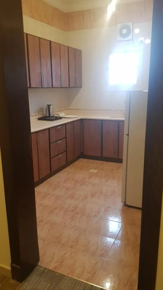 Kitchen or kitchenette in Arabian Palm Hotel