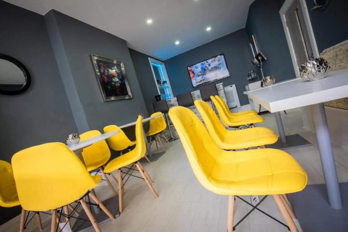 Communal lounge/ TV room in The Gables Hotel by Cherish Lewis Blackpool