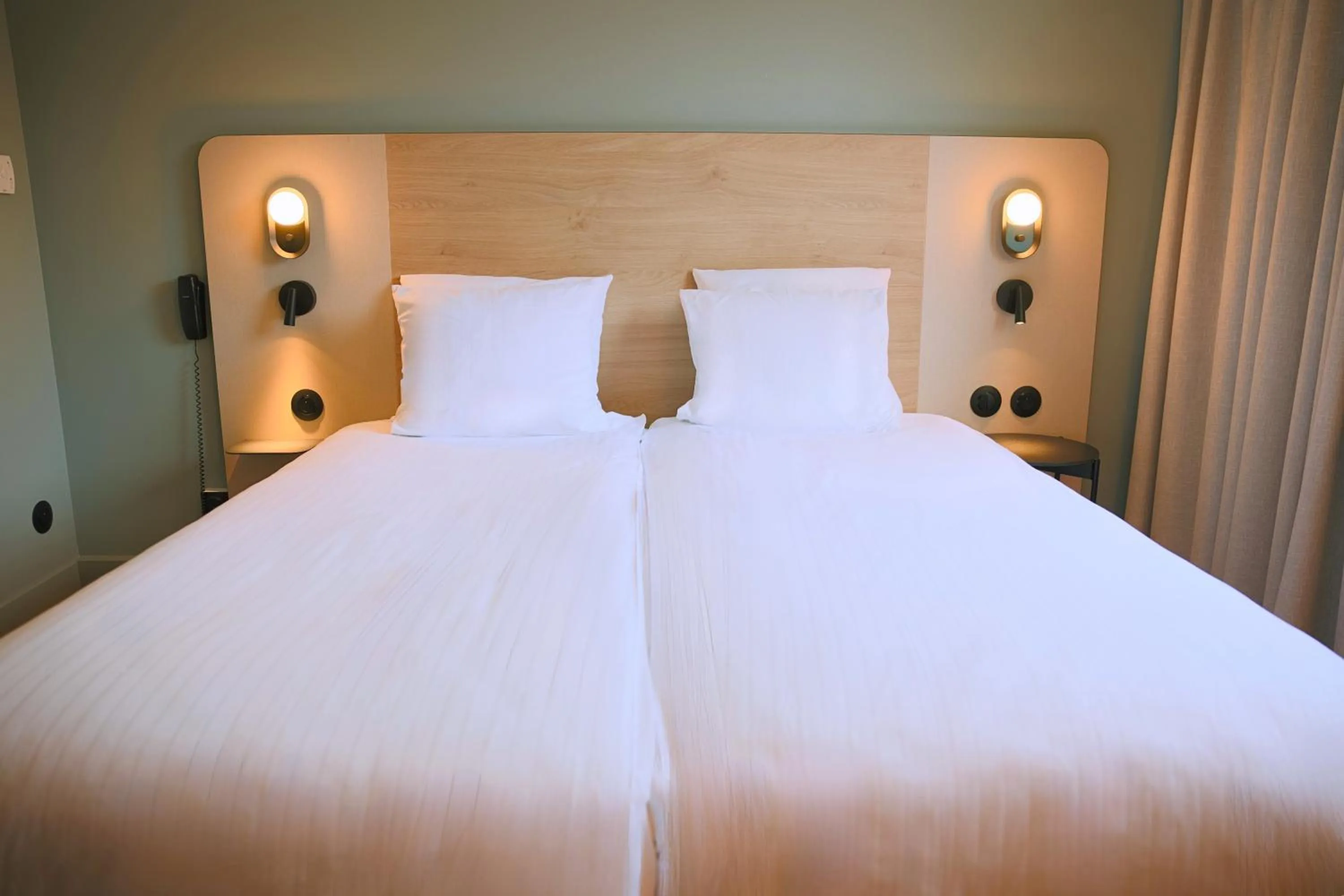 Bed in Logis Hotel L'Ours de Mutzig