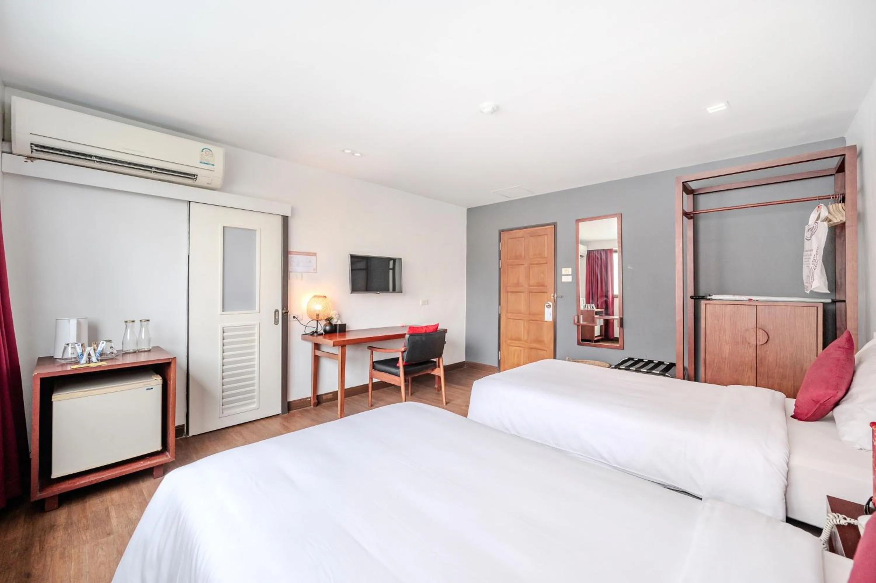 Bed in Ruamchitt Plaza Hotel