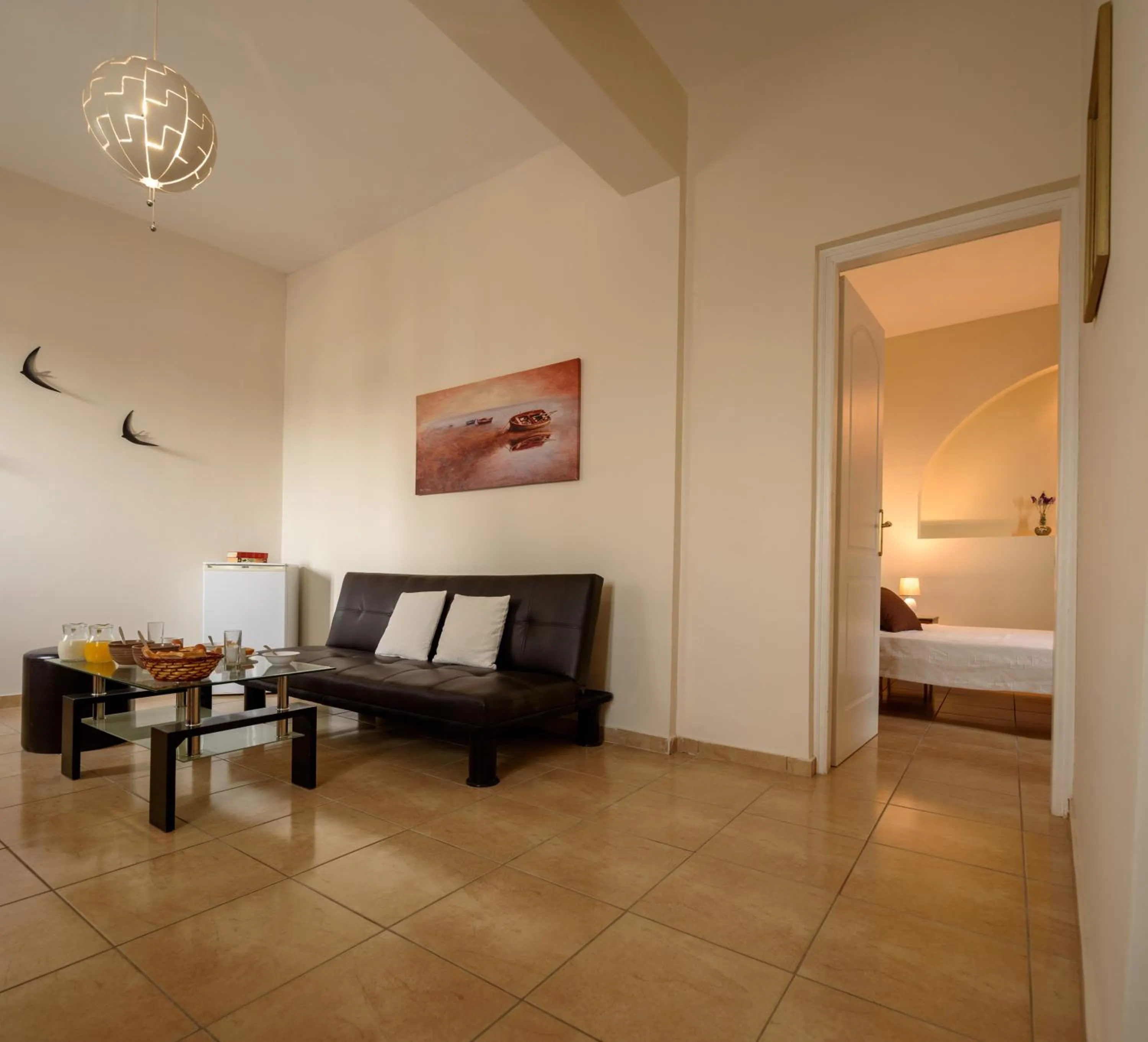 Seating area, Bed in Moonlight Apartments & Suites