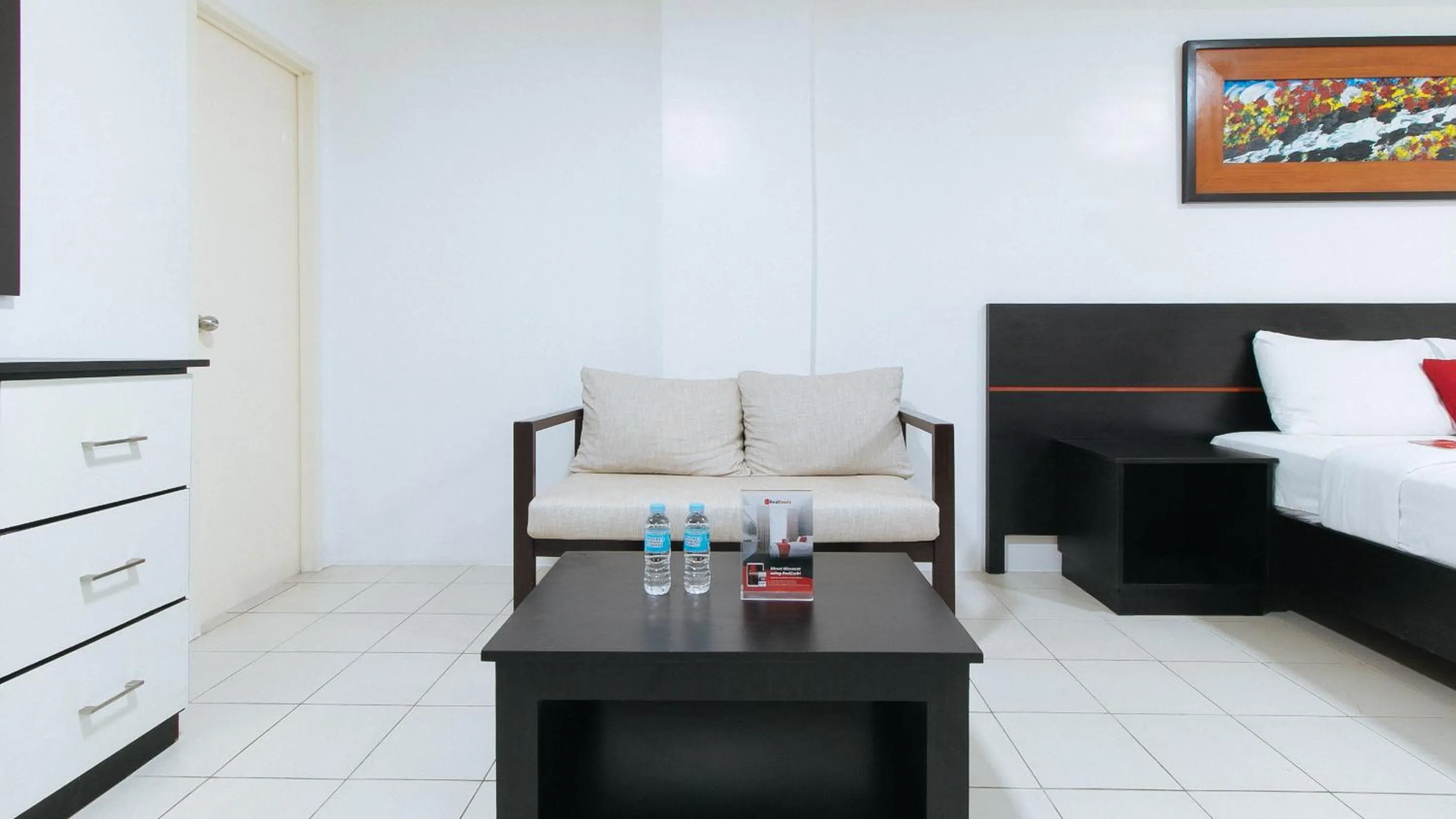 Seating area, Bed in RedDoorz Plus at Evangelista Street Makati