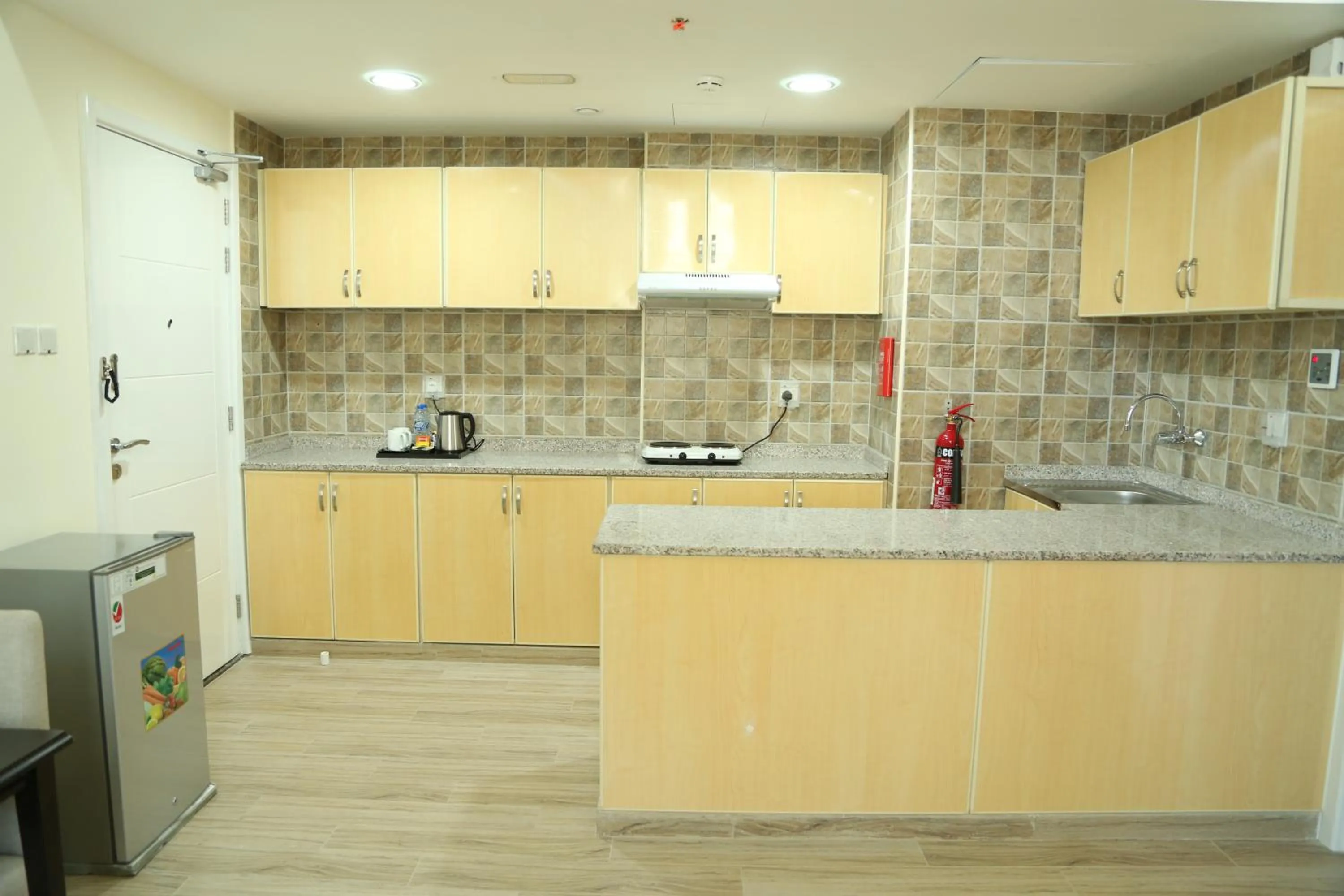 Kitchen or kitchenette in Uptown Hotel Apartment Fujairah By Gewan