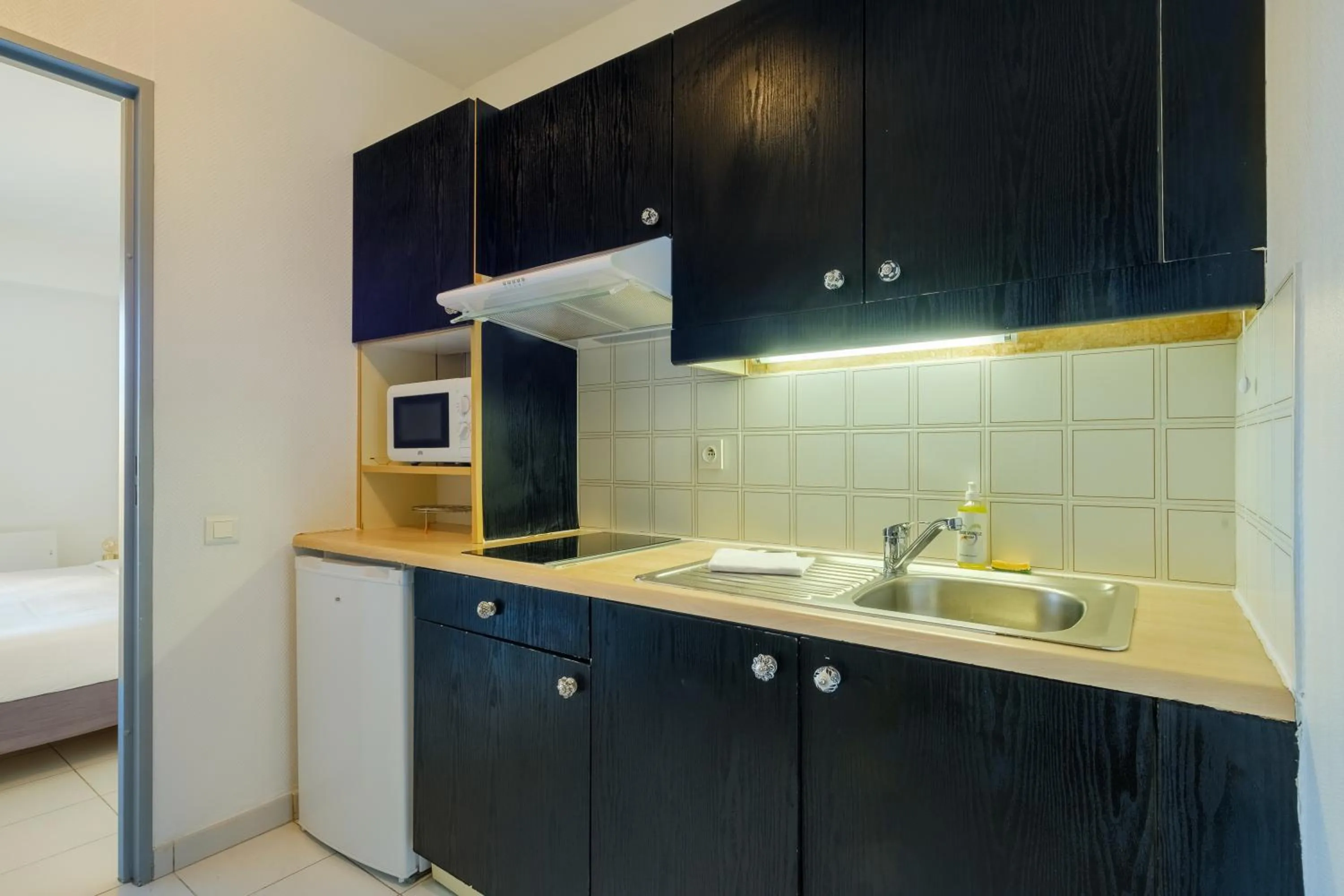 Kitchen or kitchenette in Residhotel Villa Maupassant