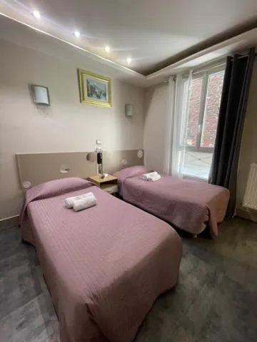 Bed in Hôtel de l'Aveyron