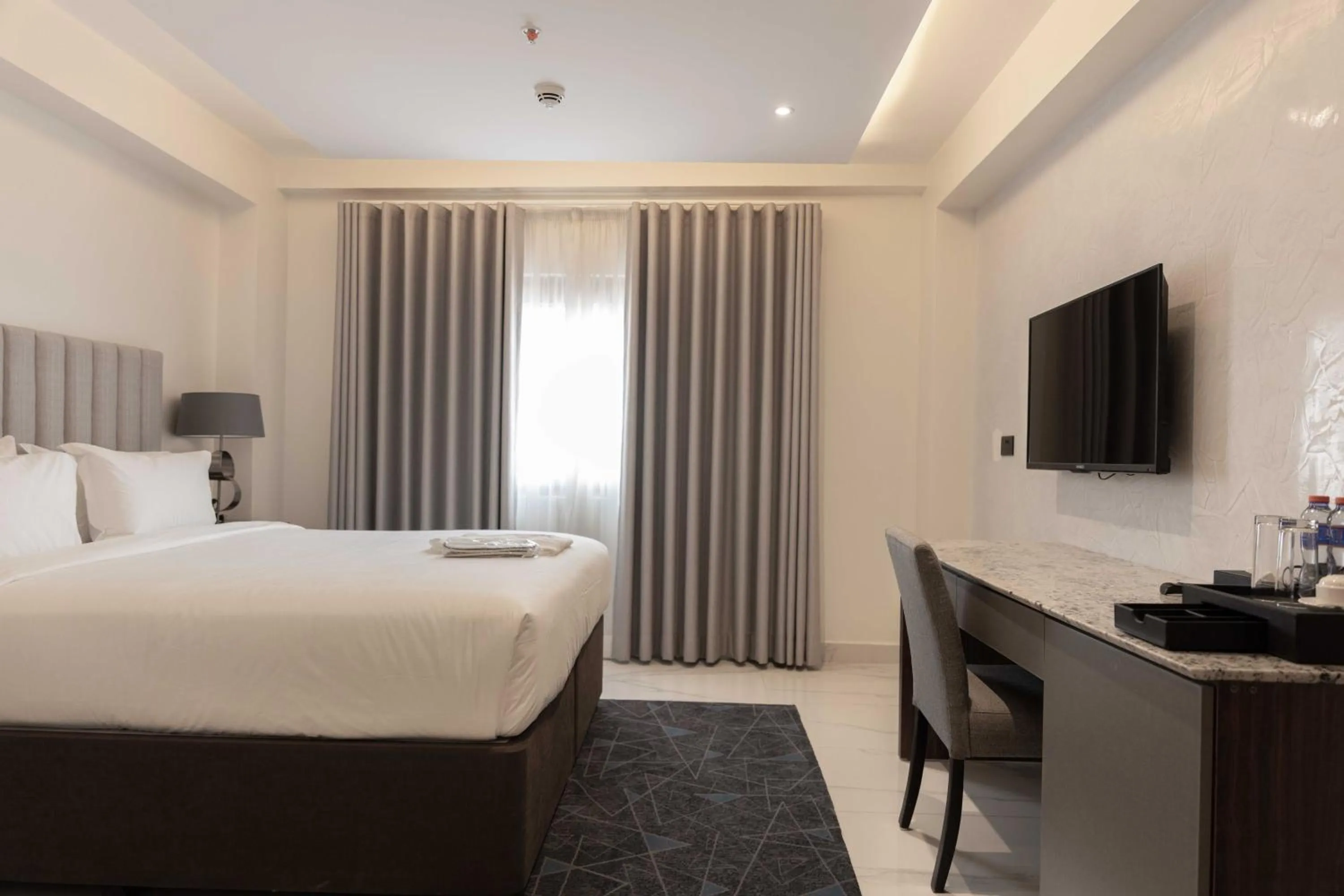 Seating area, Bed in The Palms by Eagles Airport City