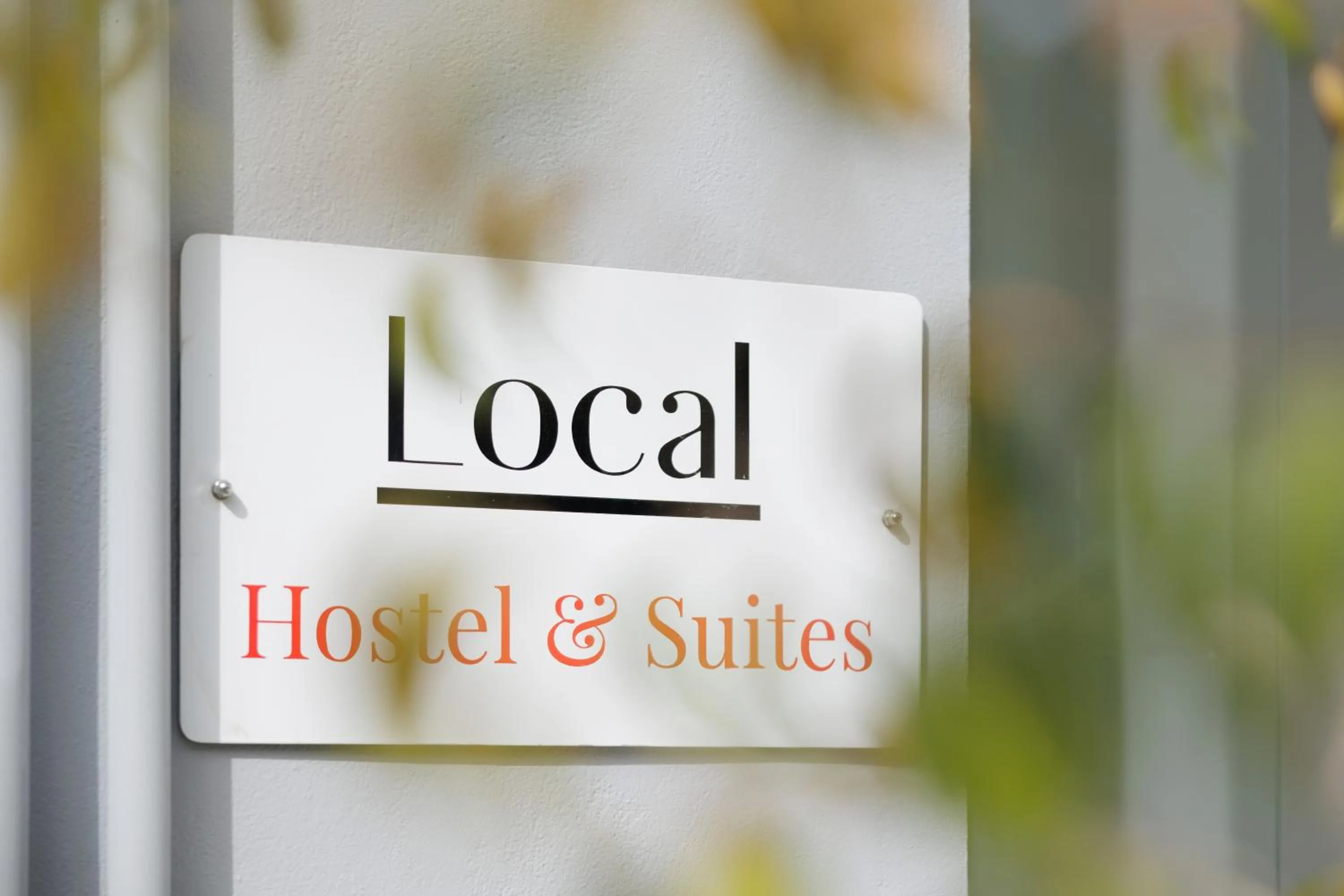 Property logo or sign in Local Hostel & Suites