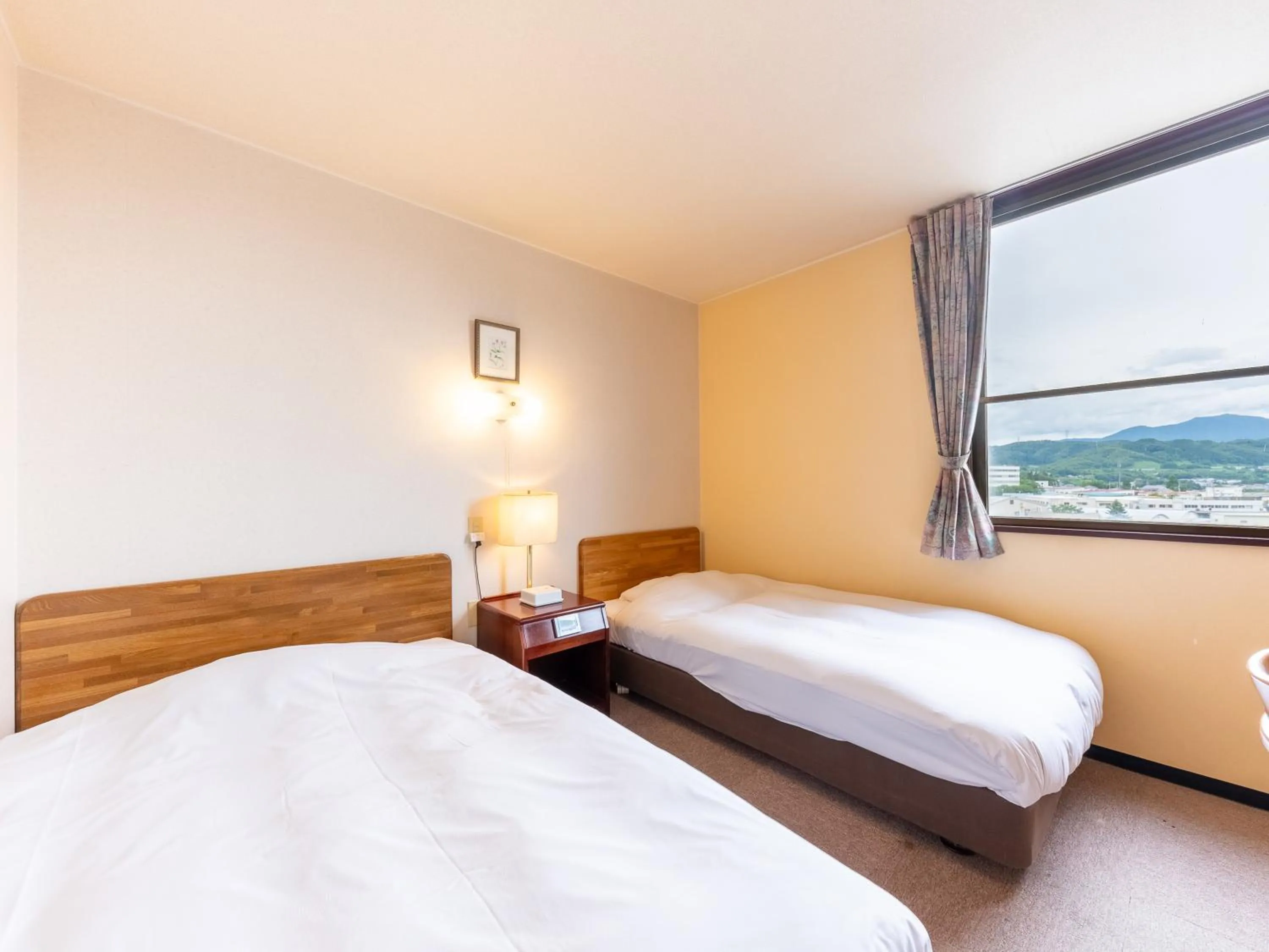 Bed in Tabist Travel Inn Shinshu Nakano