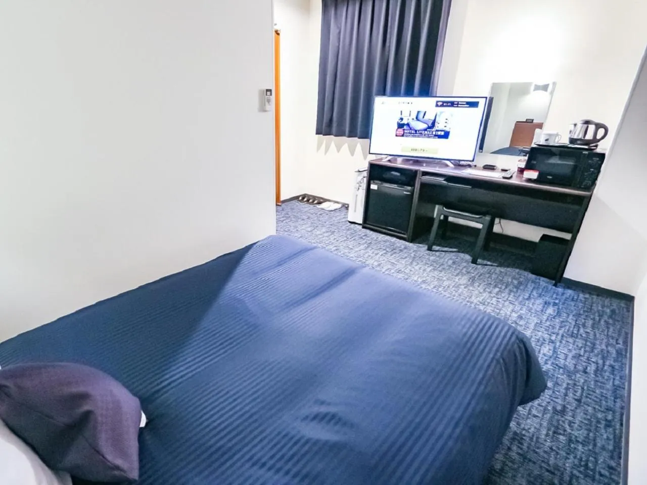 Bed in HOTEL LiVEMAX BUDGET Fuji Ekimae