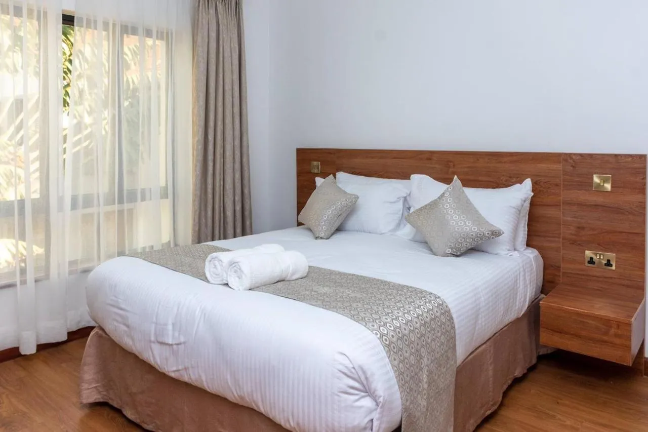 Bed in CySuites Apartment Hotel