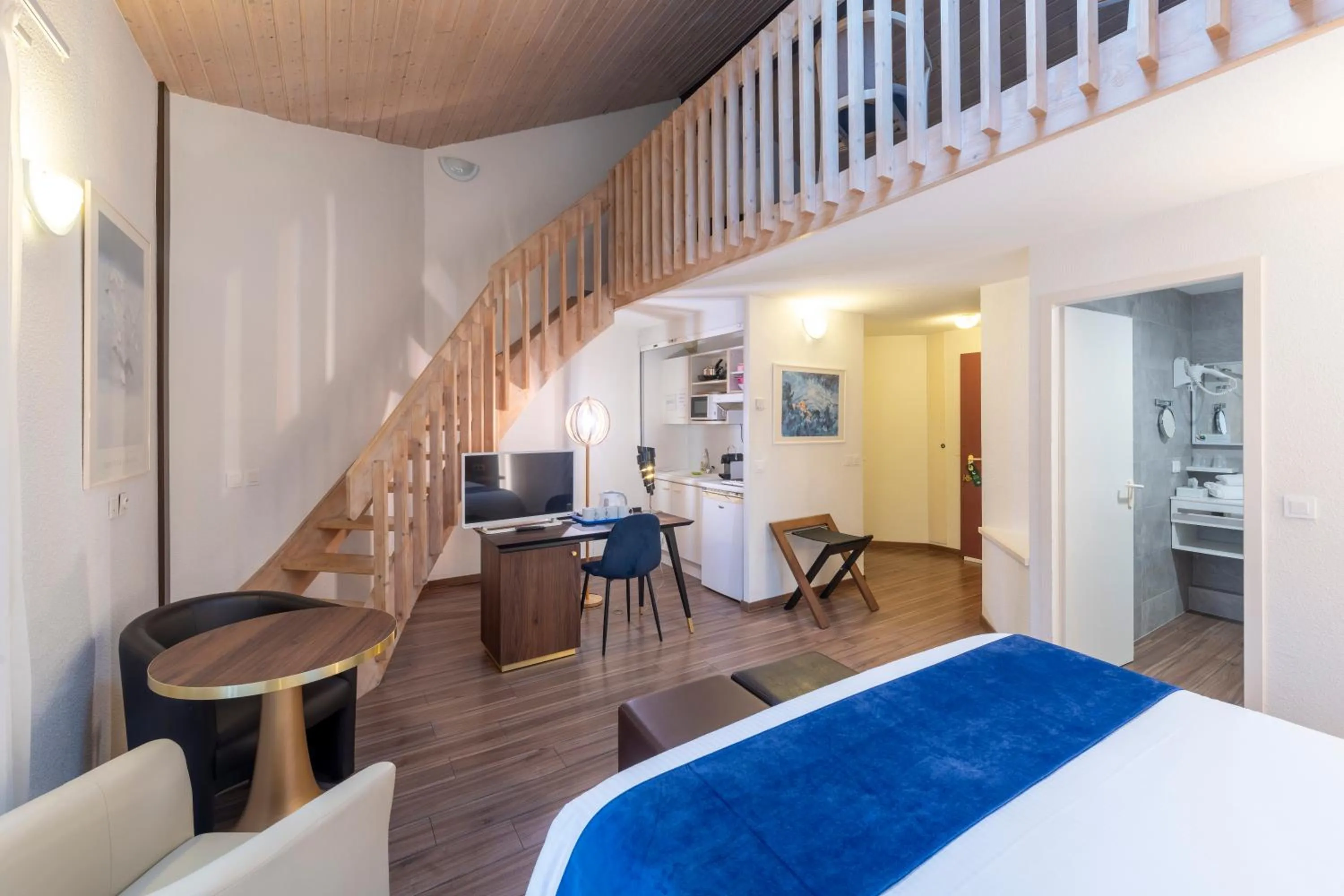 Bed in Logis Hotel Arc En Ciel