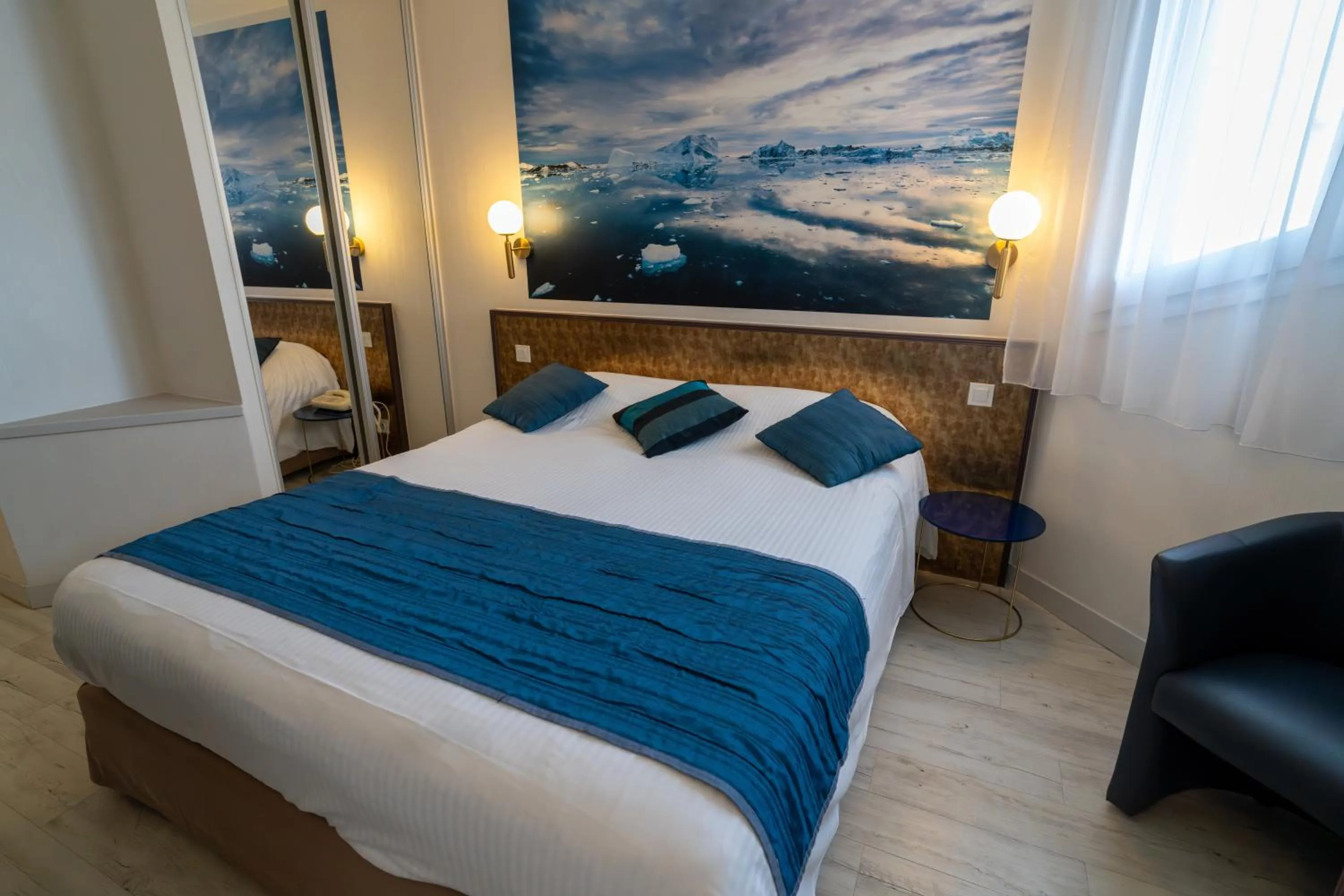 Bed in Logis Hotel Arc En Ciel