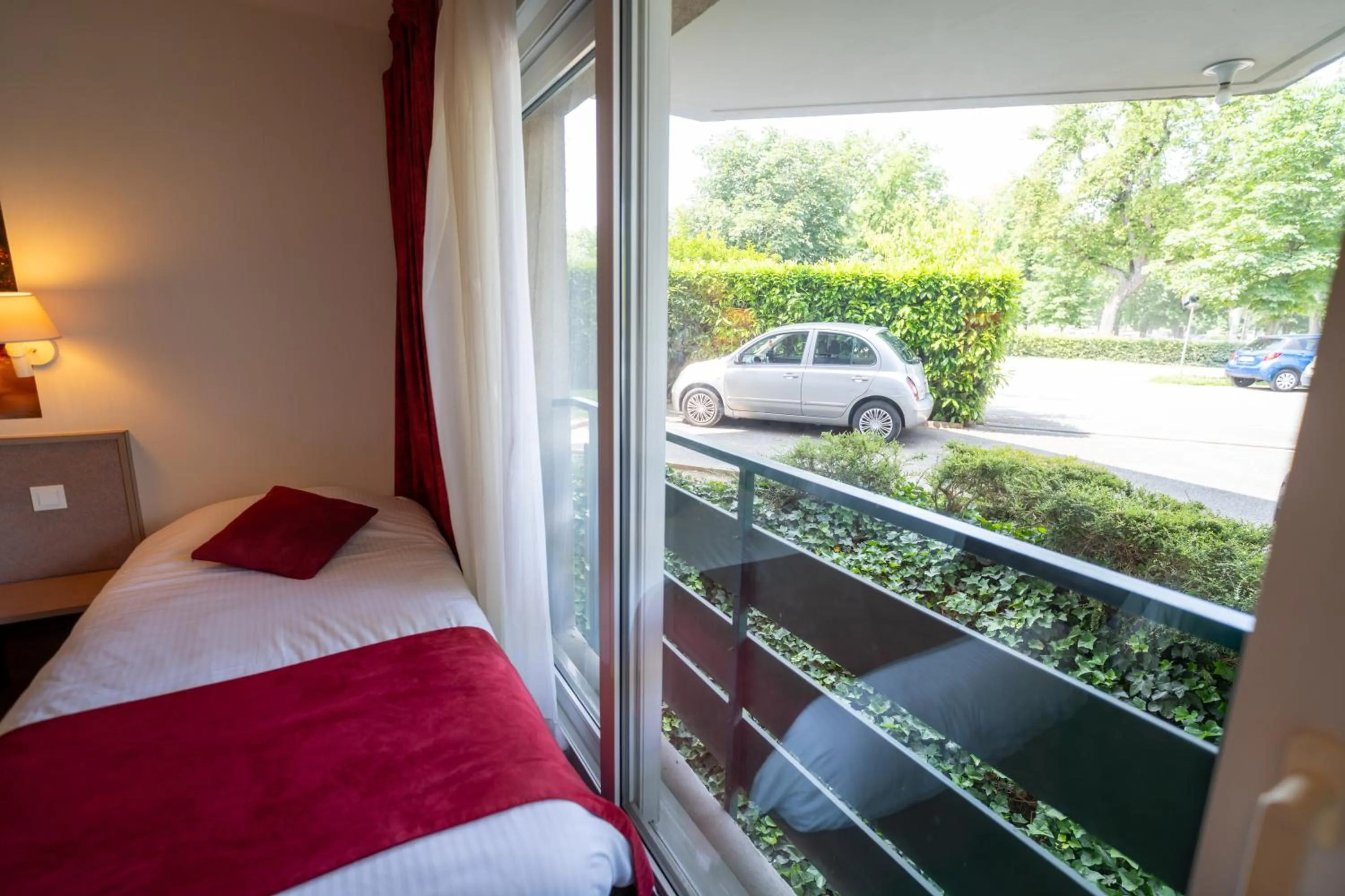 Bed in Logis Hotel Arc En Ciel