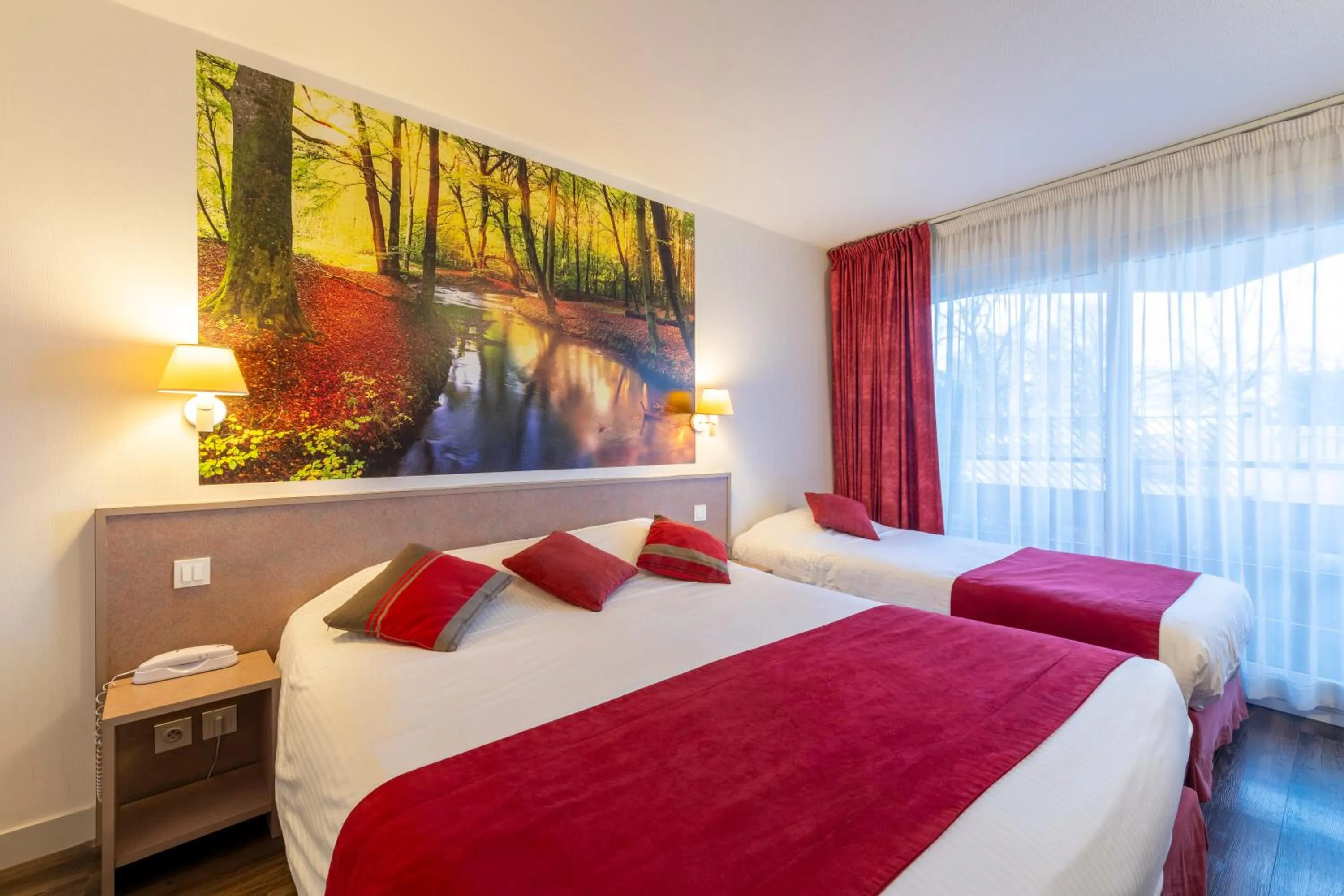 Bed in Logis Hotel Arc En Ciel