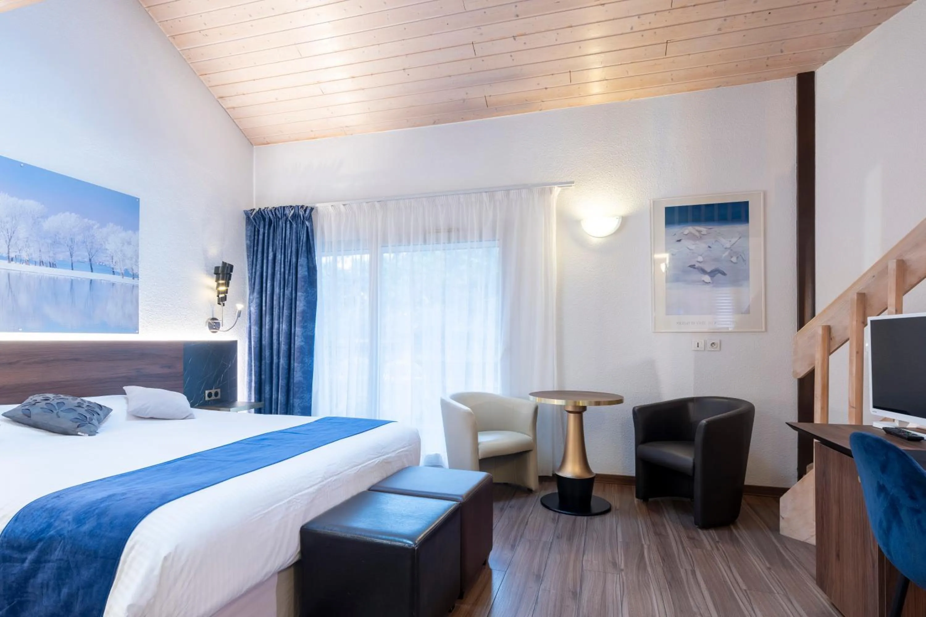 Bed in Logis Hotel Arc En Ciel