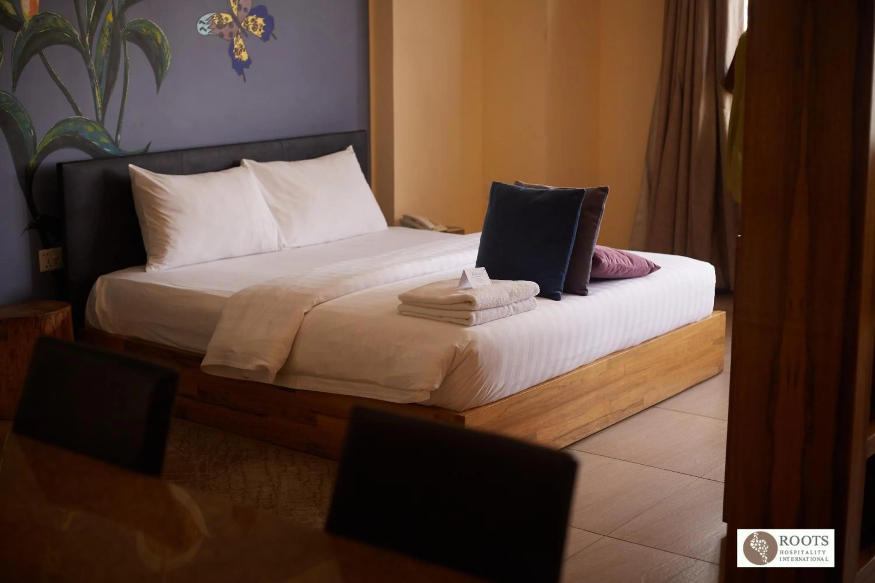 Bed in Roots Hotel Apartment