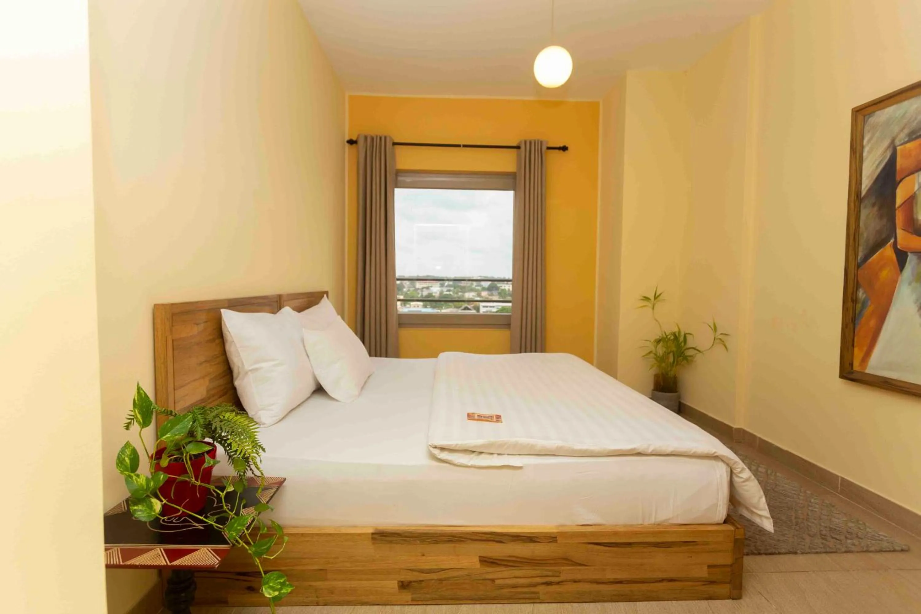 Bed in Roots Hotel Apartment