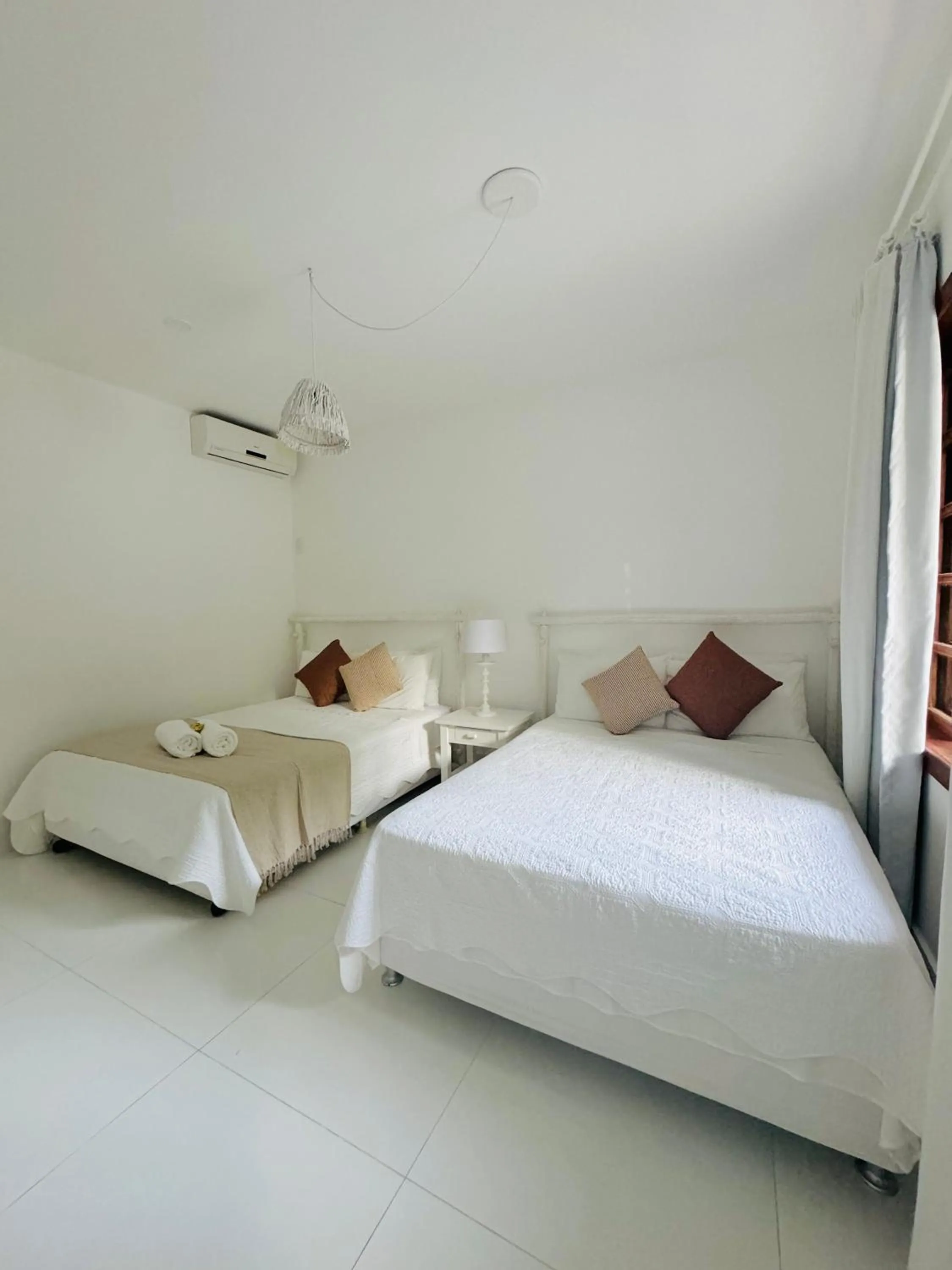 Bed in Pousada Coisa e Tao