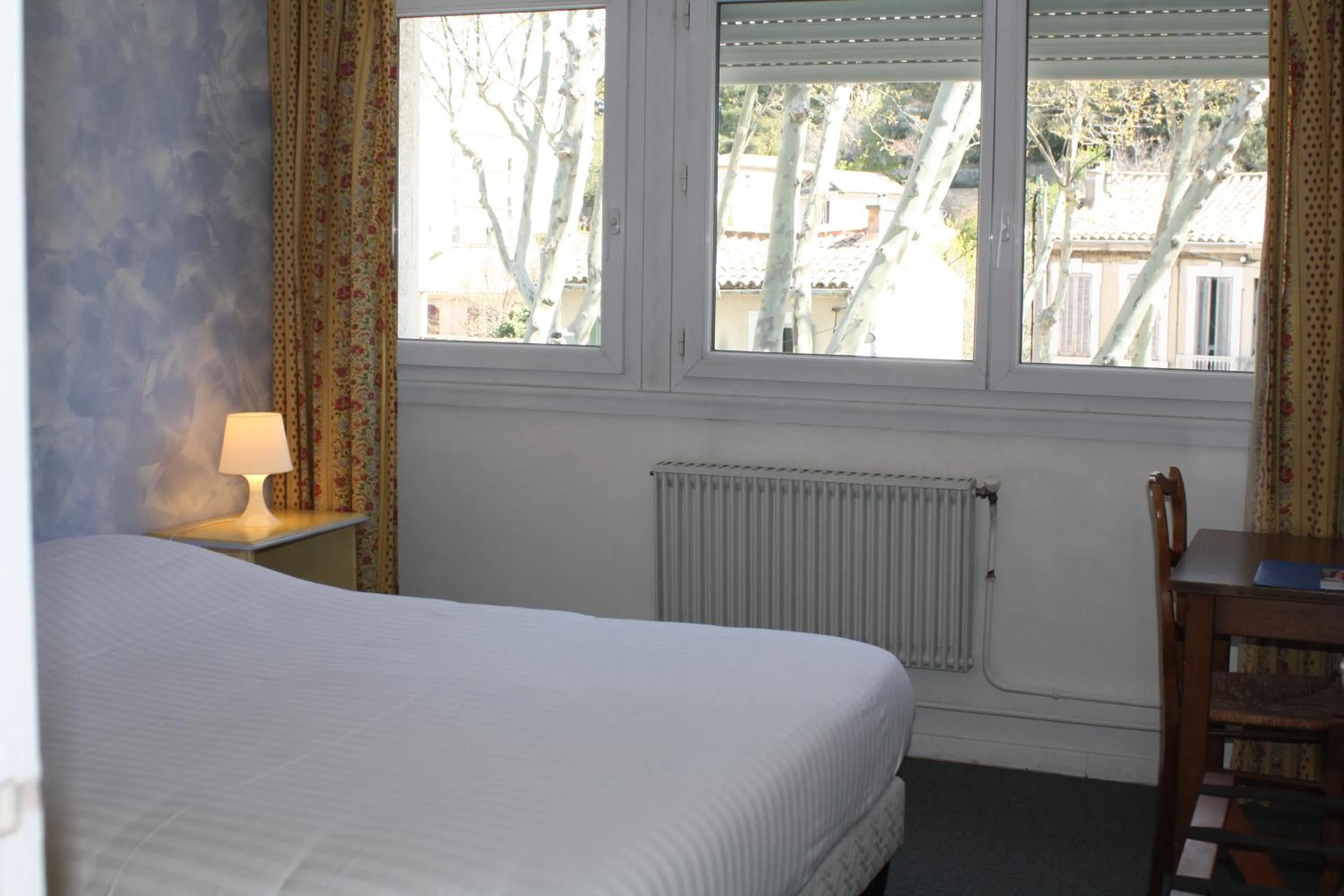 Bed in Logis Hotel du Midi