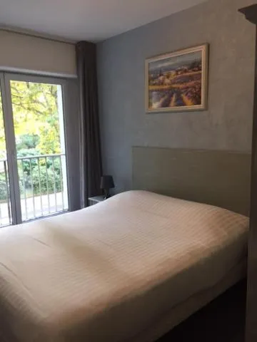 Bed in Logis Hotel du Midi