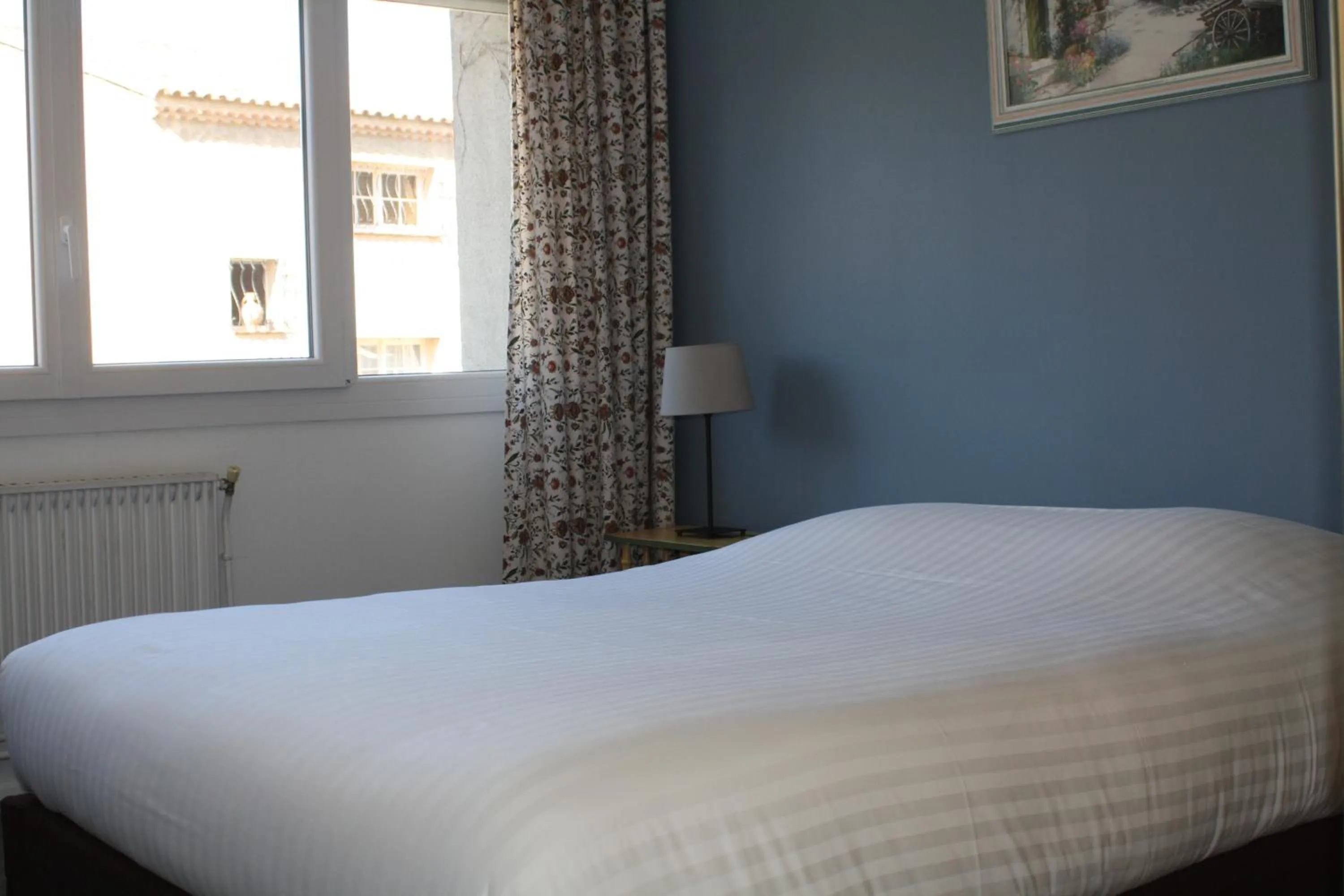 Bed in Logis Hotel du Midi