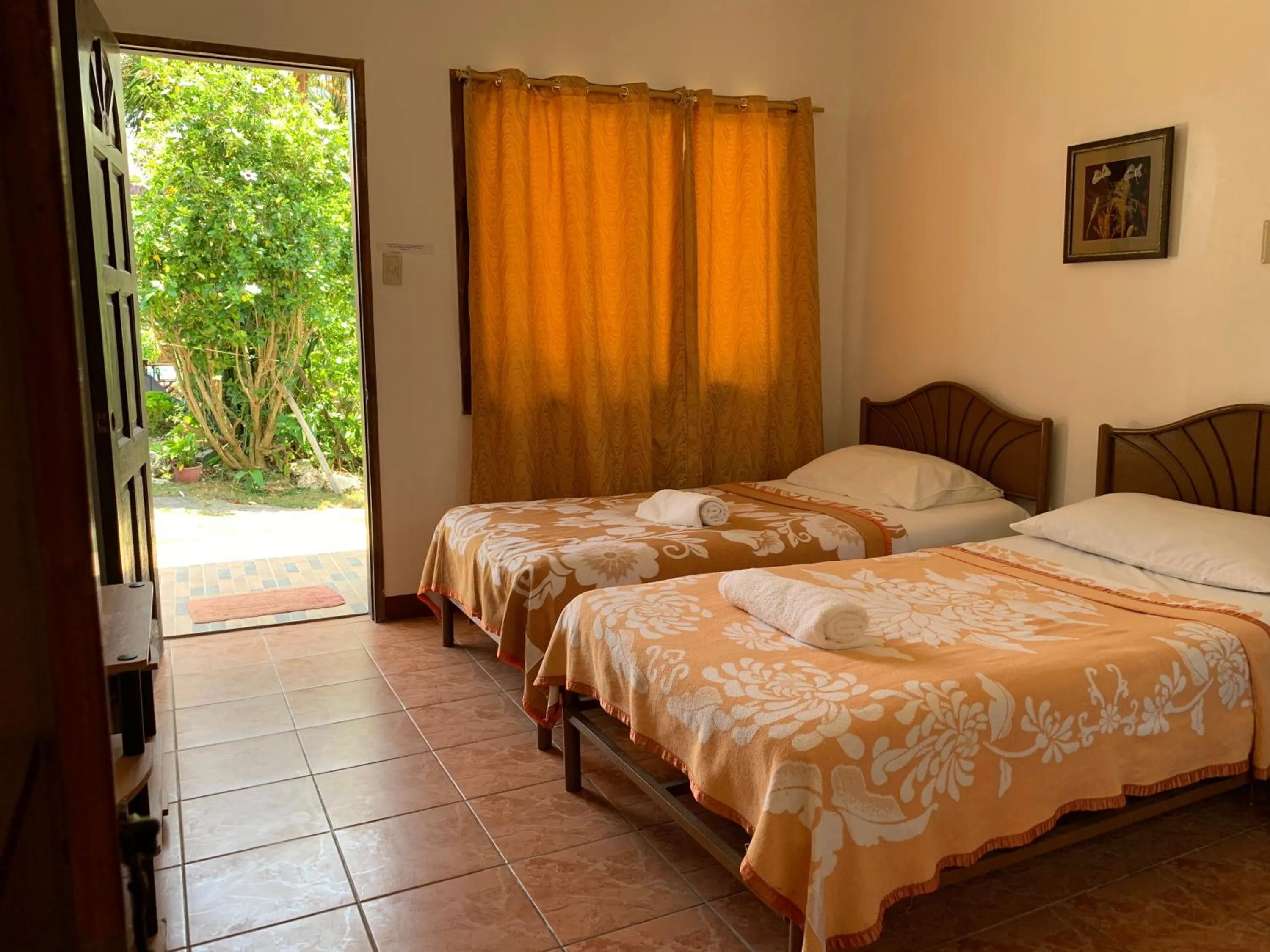 Bed in Eve's Kiosk Dive Resort