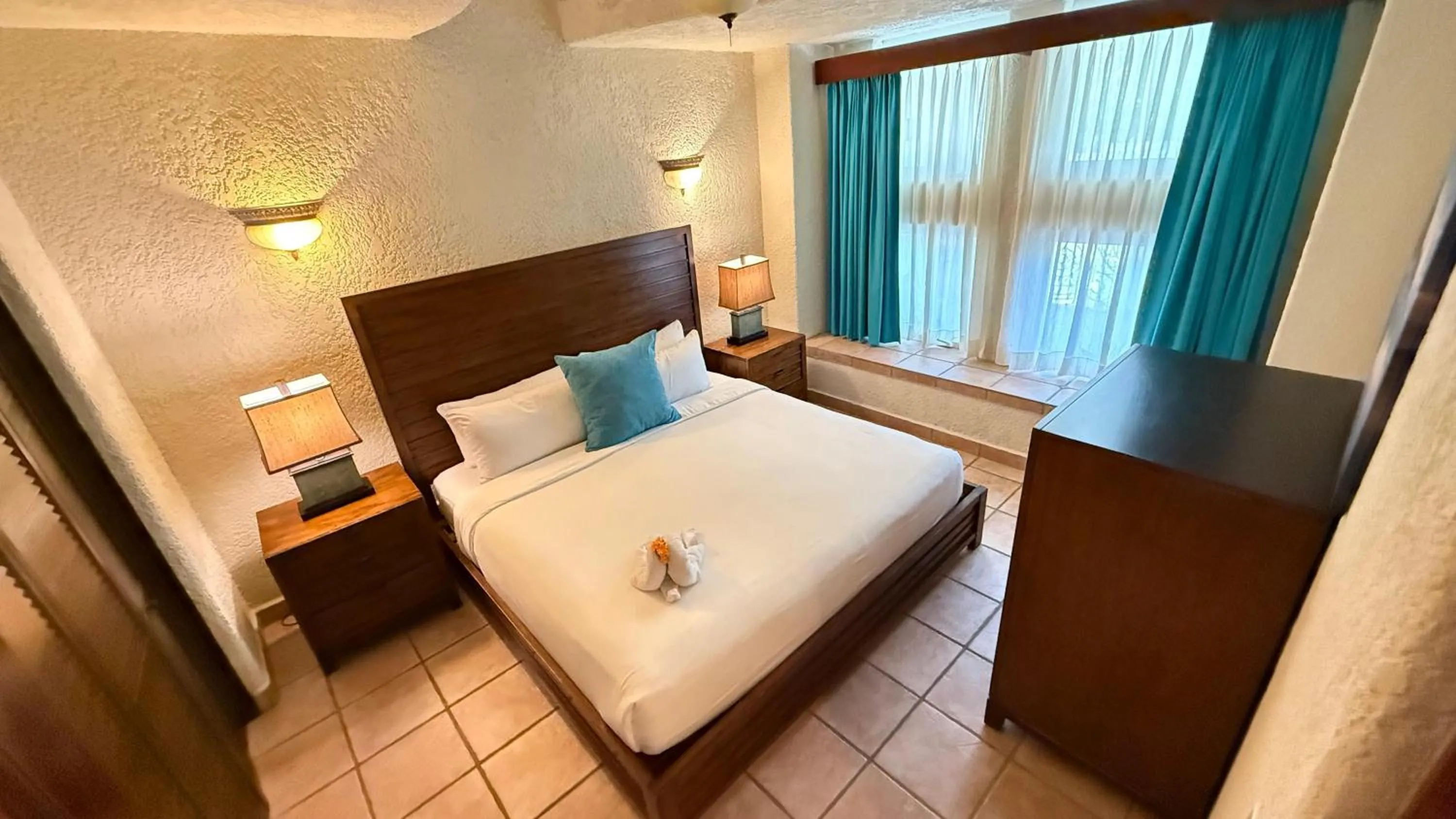 Bed in Mayan Princess Beach & Dive Resort
