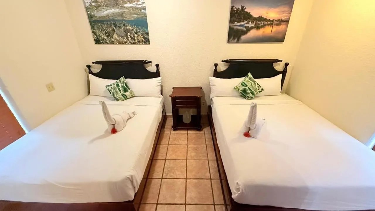Bed in Mayan Princess Beach & Dive Resort