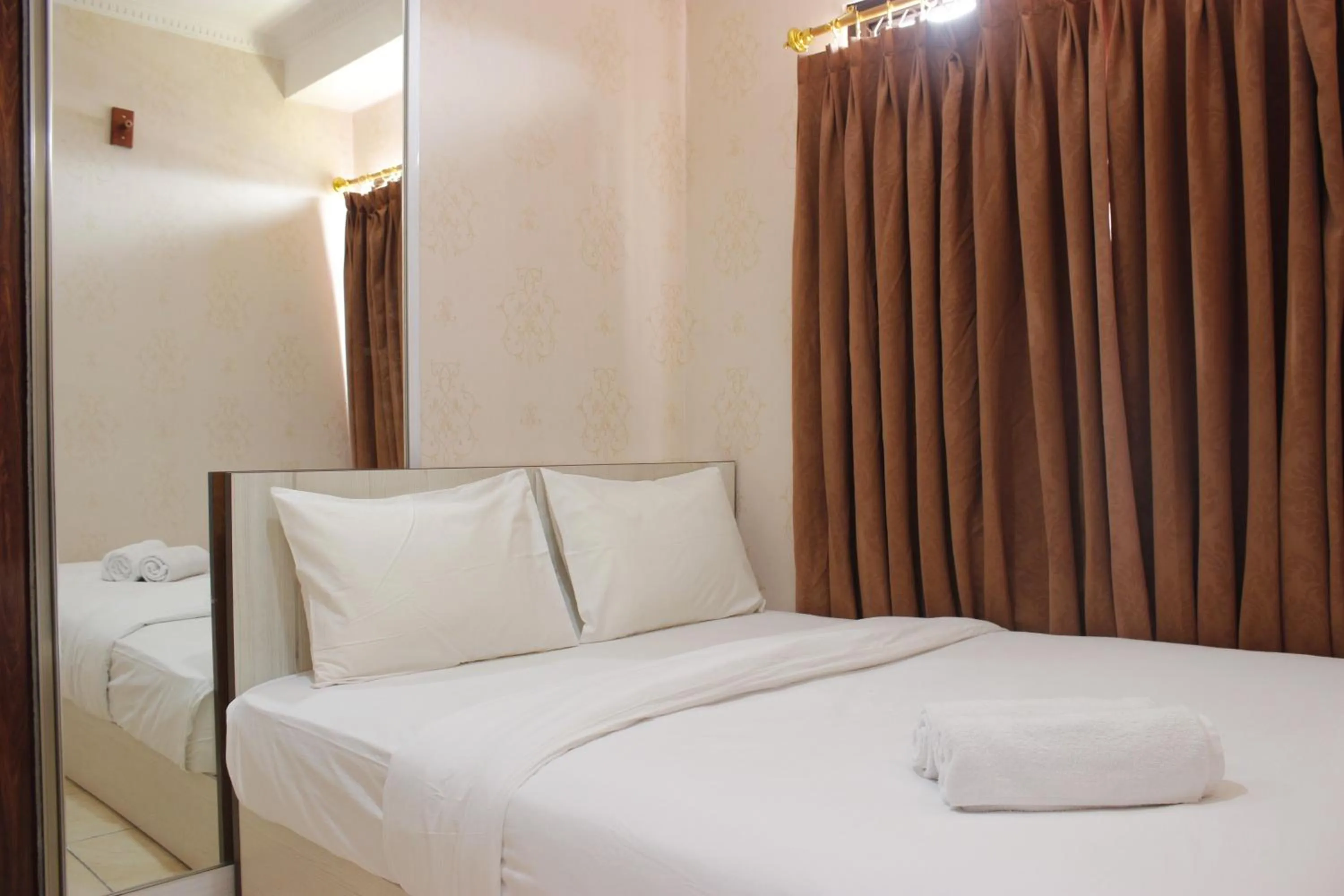 Bed in Cozy 2BR Tamansari Panoramic Apartment By Travelio