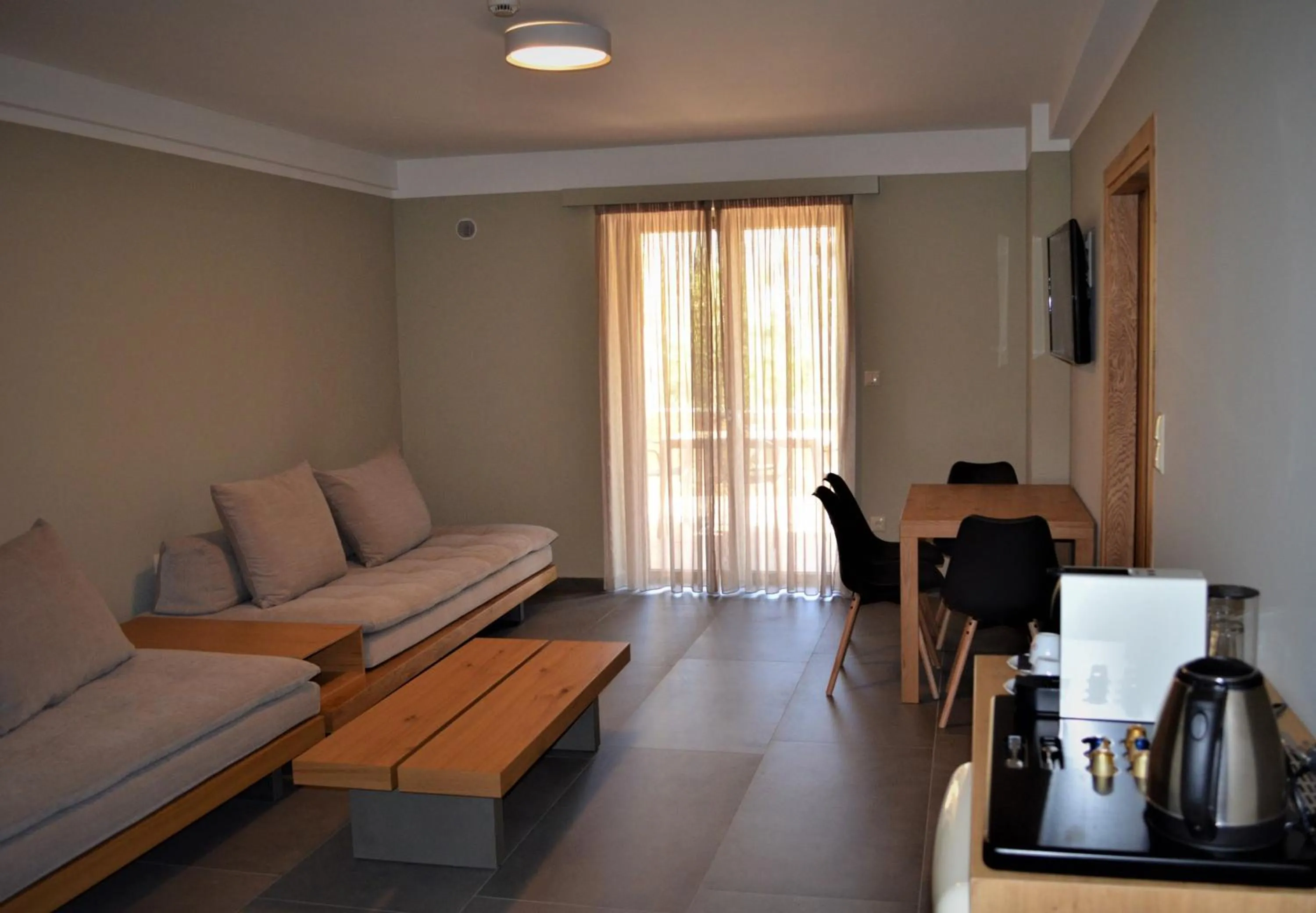 Seating area, Bed in Diapori Suites Hotel