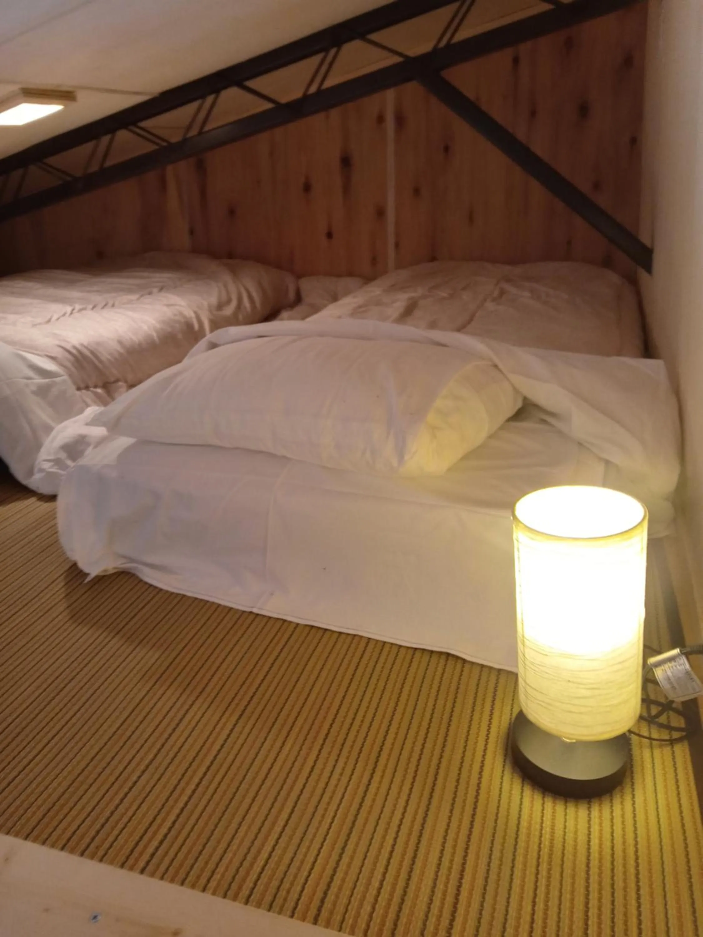 Bed in HAKUBA IKEDA LIFE KAN APARTMENTS