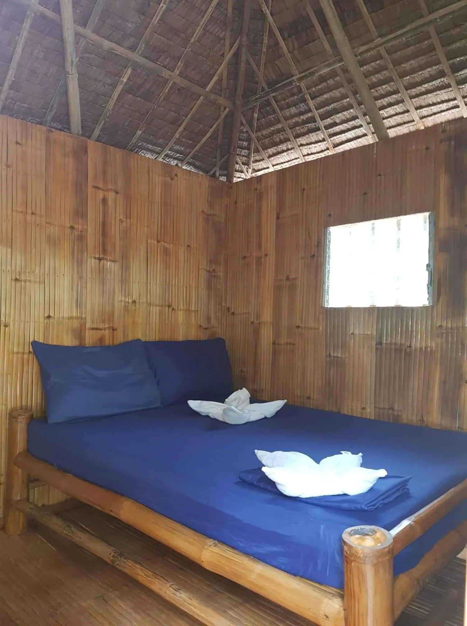 Bed in Nirvana Bamboo & Dive resort