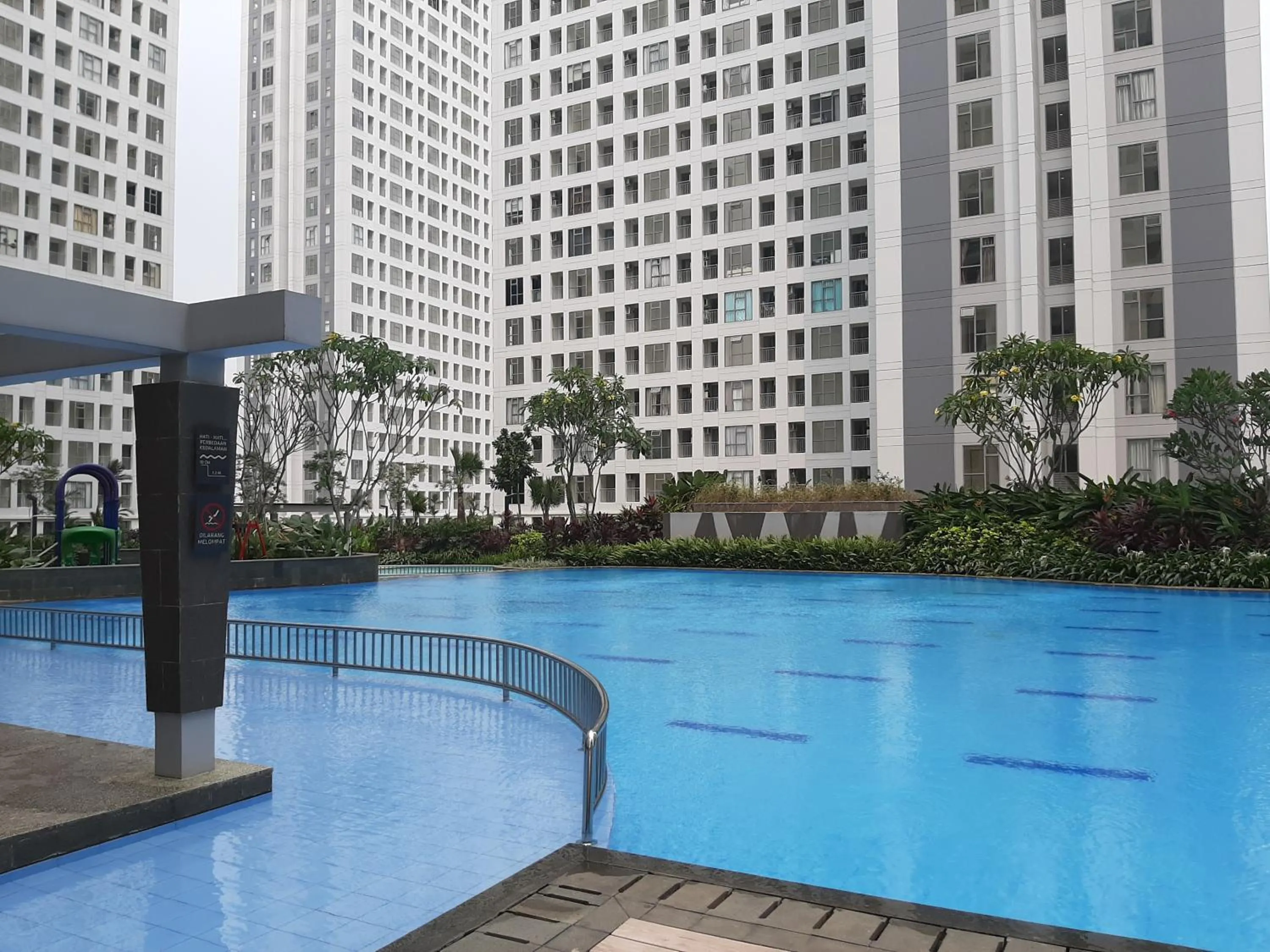 Swimming pool in Comfortable 2BR Apartment at M-Town Residence By Travelio
