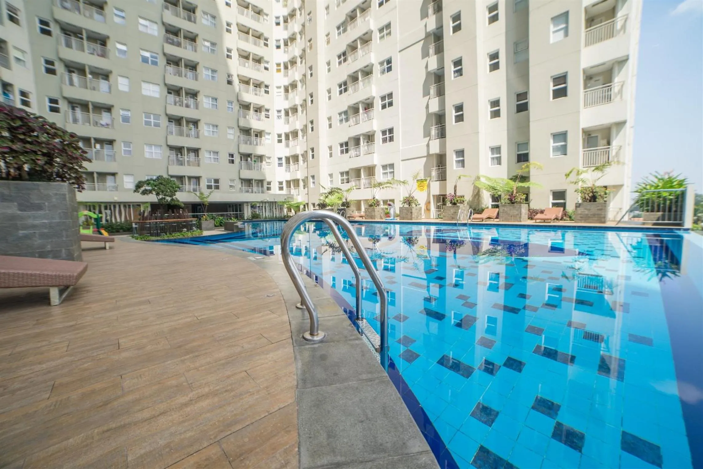 Swimming pool in Quiet 2BR Apartment @ Parahyangan Residence Apartement with Mountain View By Travelio