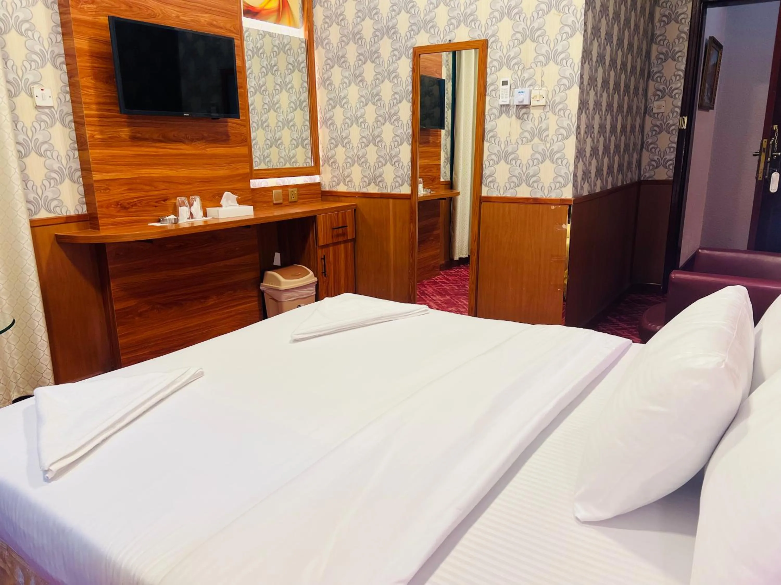 Bed in Parasol Hotel