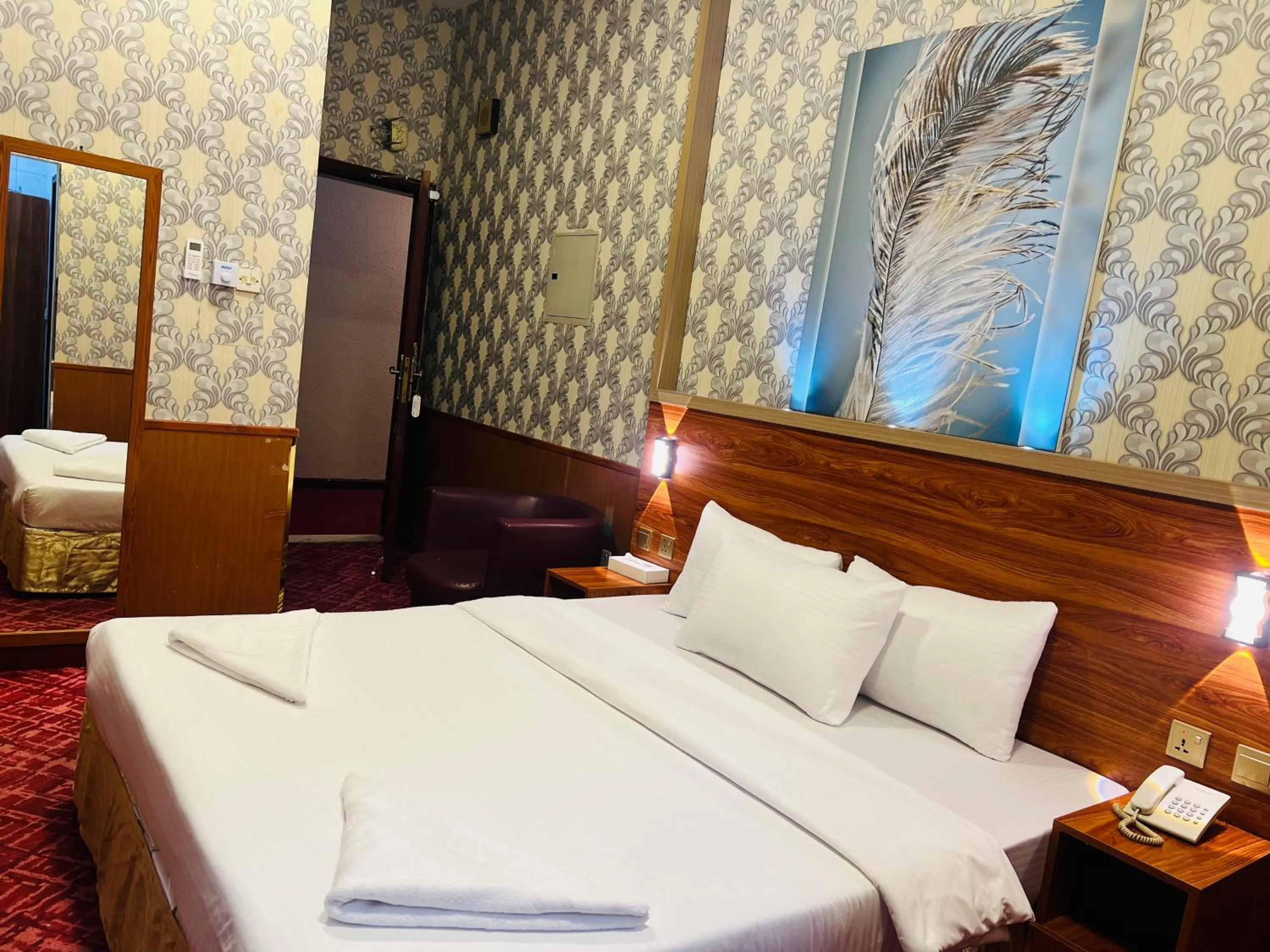 Bed in Parasol Hotel