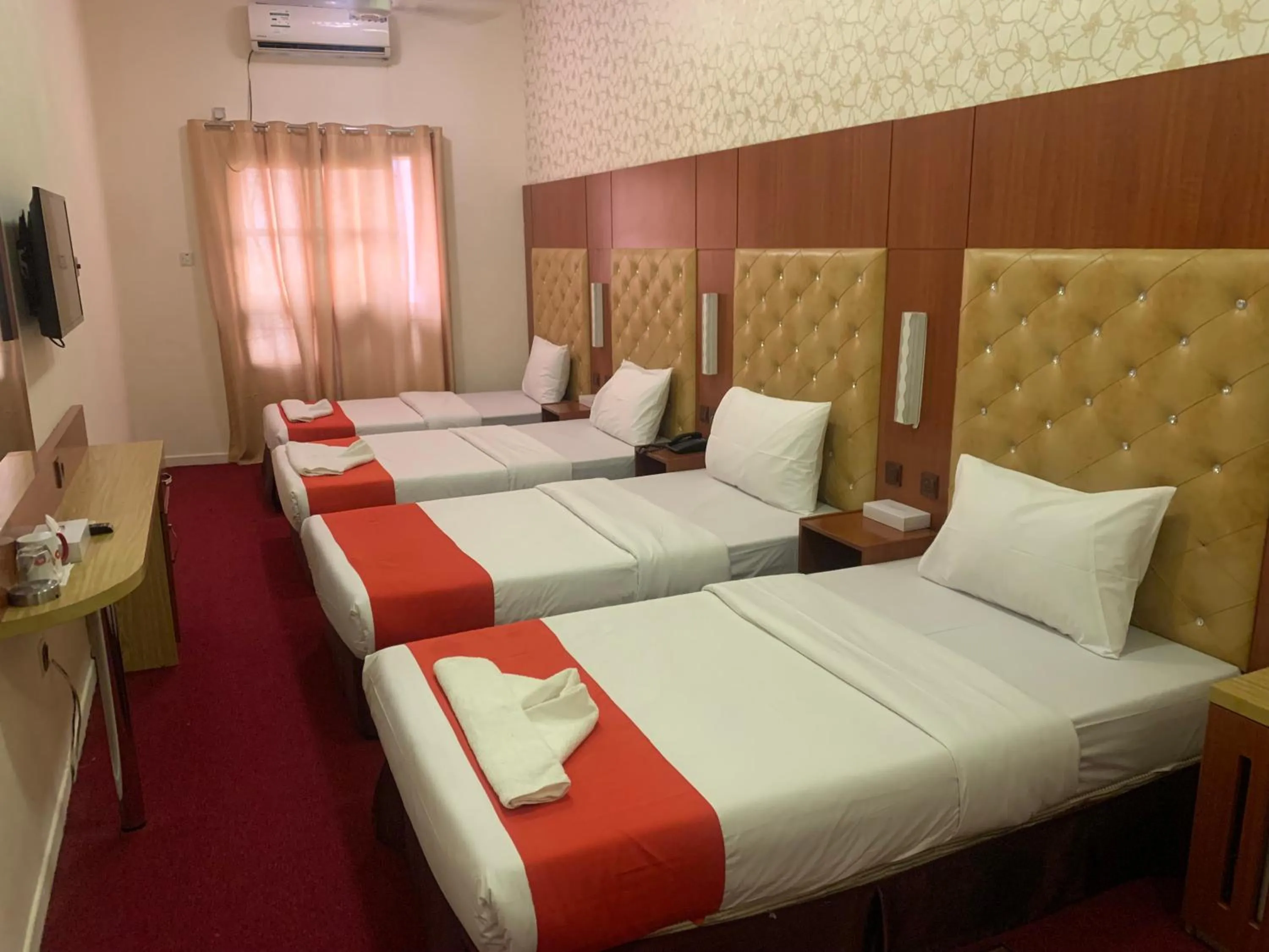 Bed in Parasol Hotel