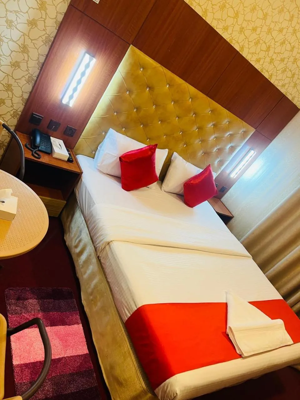 Bed in Parasol Hotel