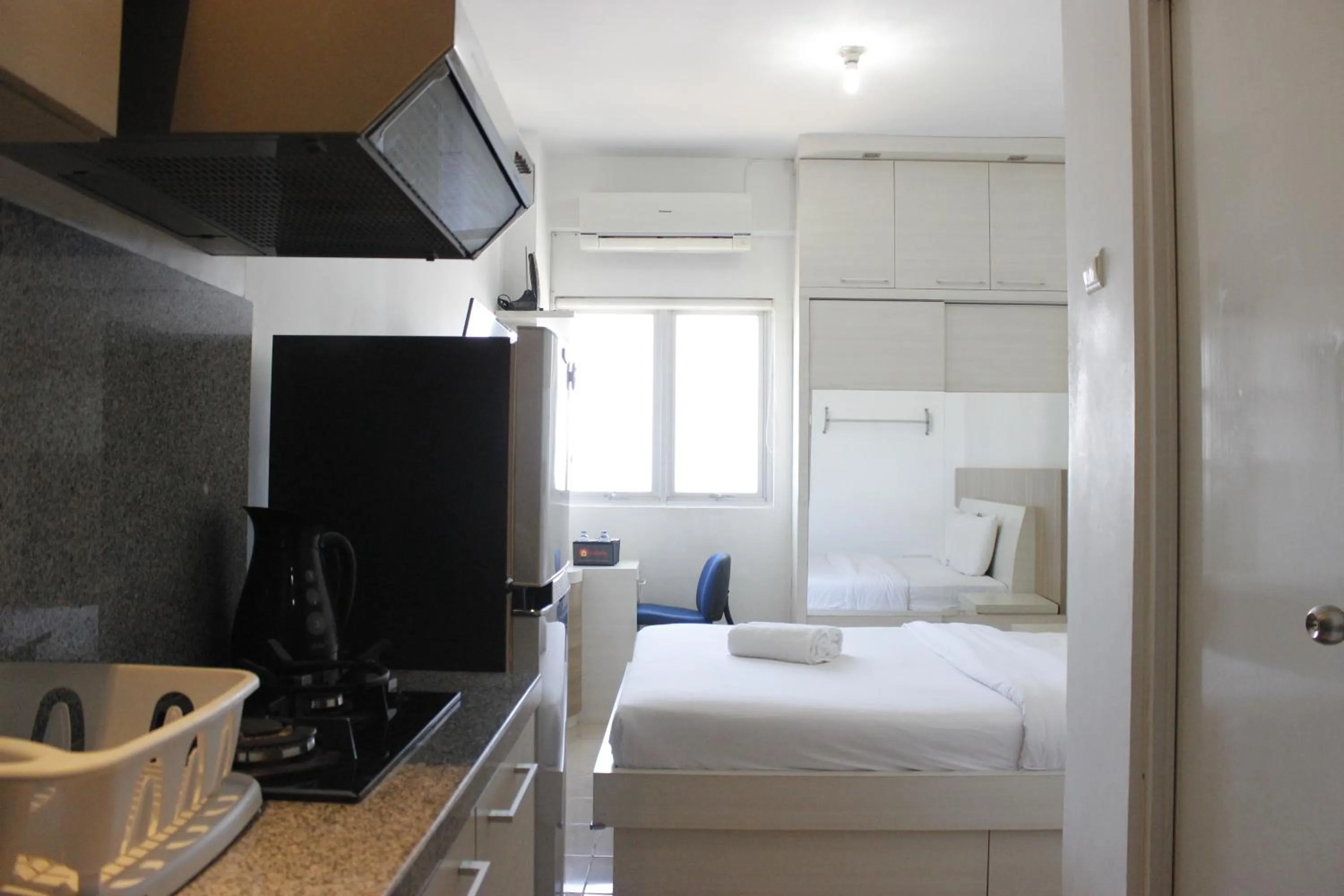 Bed in Minimalist Studio Apartment at The Suite @Metro By Travelio