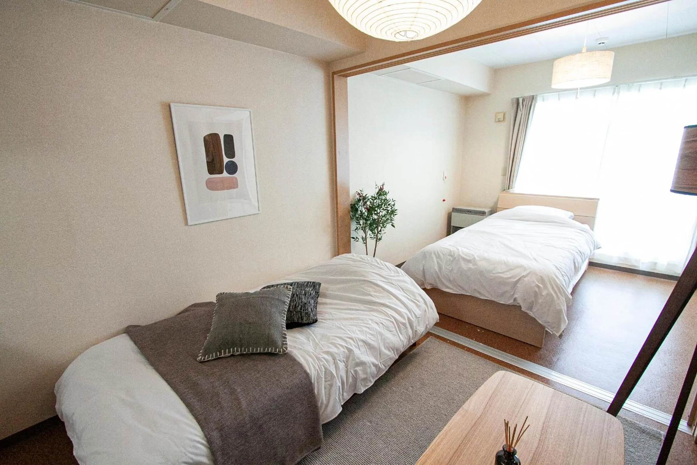 Bed in UCHI Living Stay Otaru Suitengu