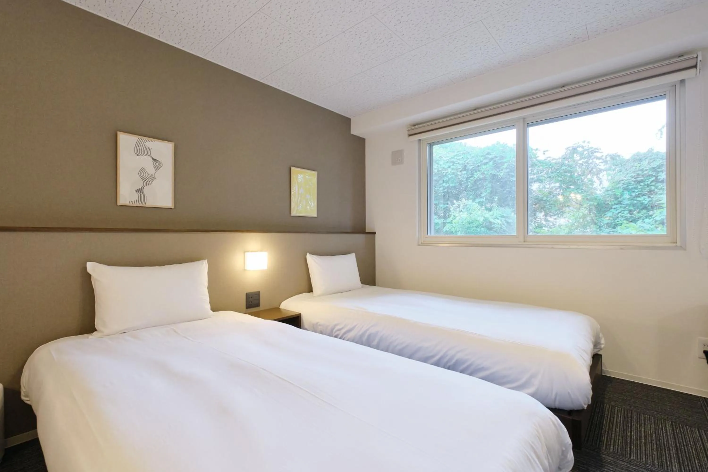 Bed in UCHI Living Stay Otaru Suitengu