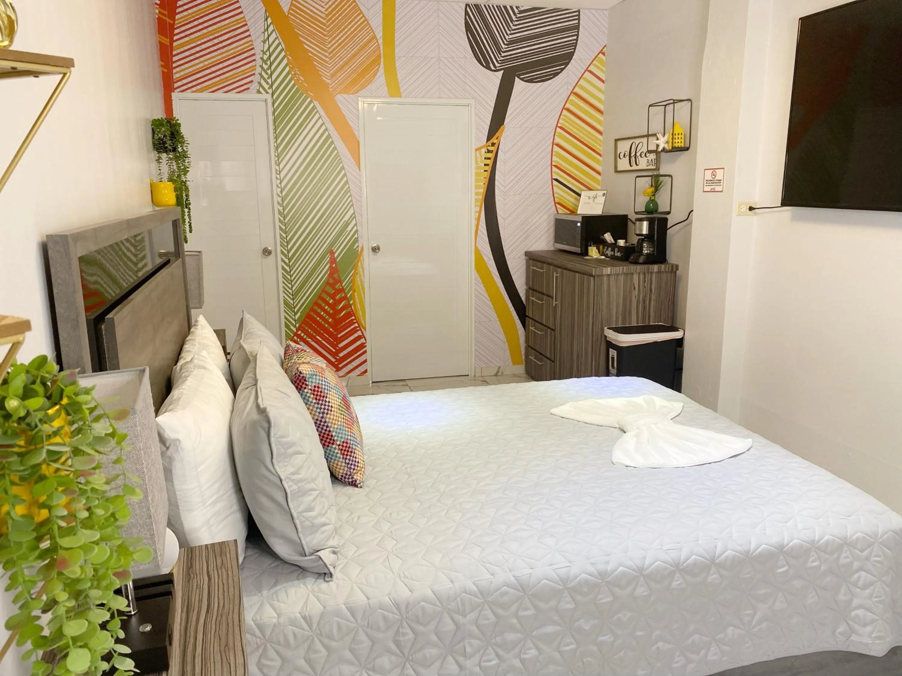 Bed in Itza-Bella Suites