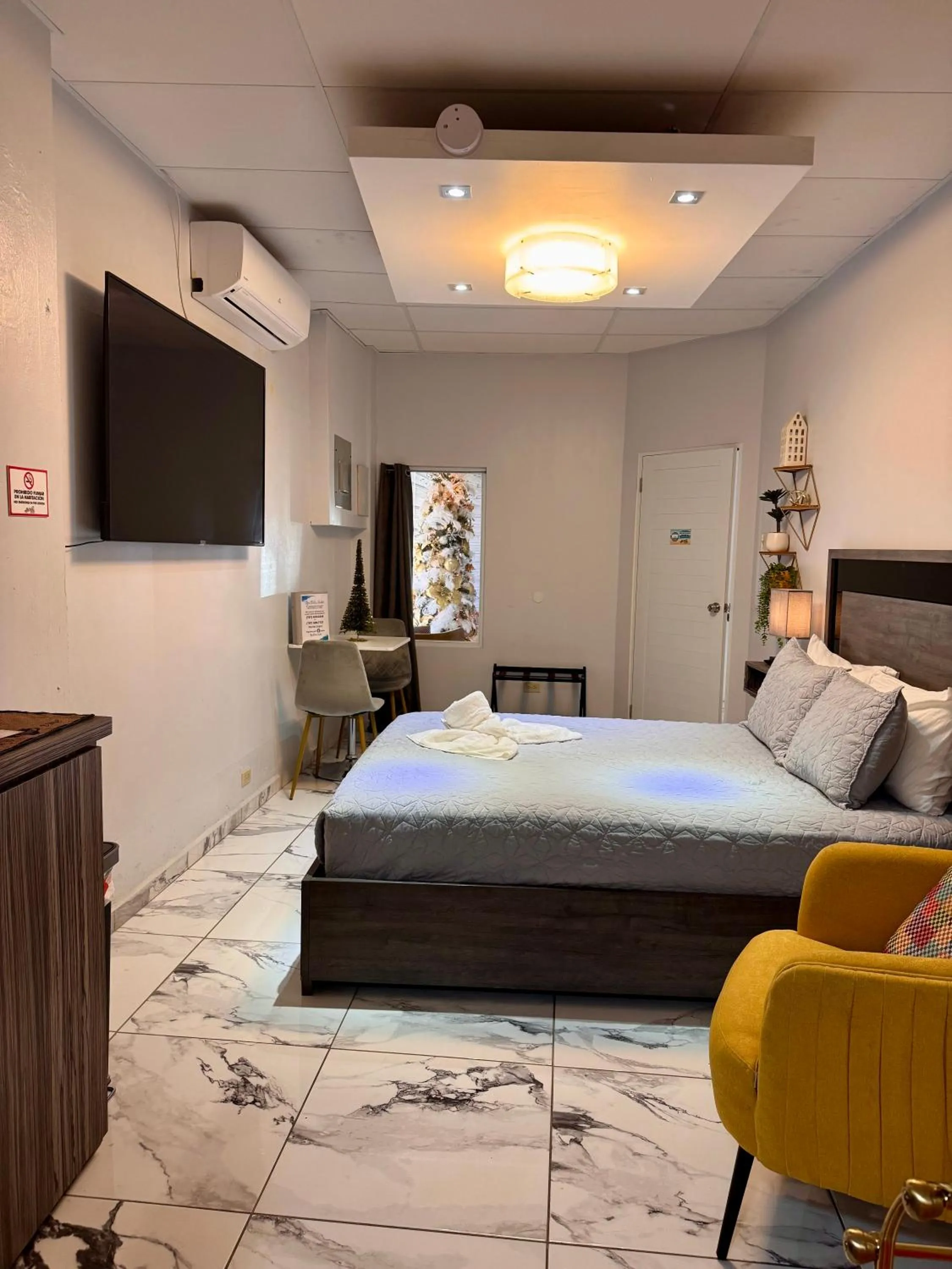 Bed in Itza-Bella Suites