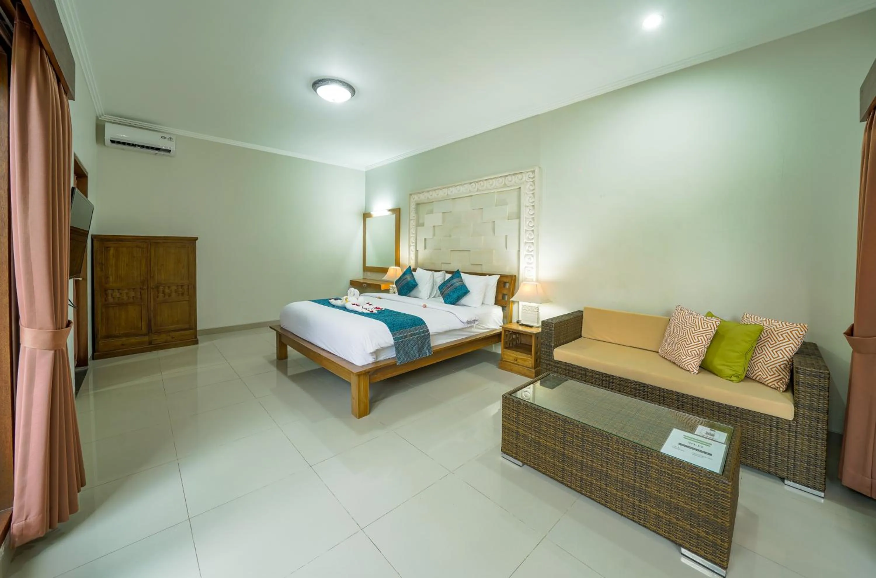 Bed in Three Brothers Bali Legian Bungalows & Villas