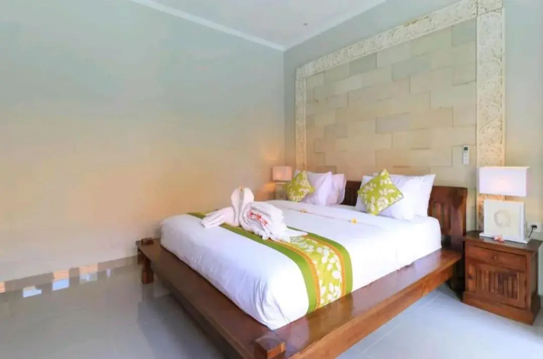 Bed in Three Brothers Bali Legian Bungalows & Villas Bed in Three Brothers Bali Legian Bungalows & Villas